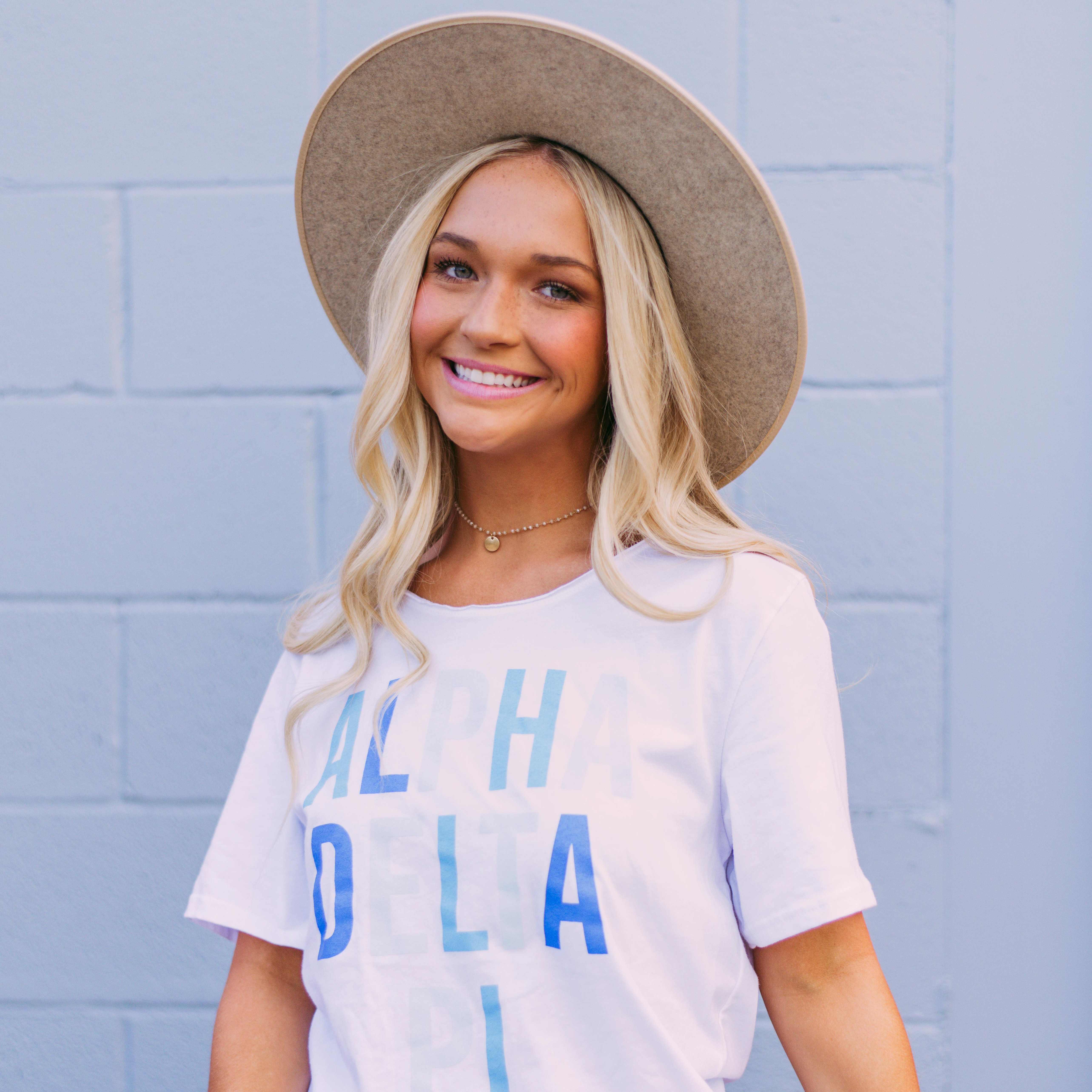 girl wearing a pi phi ash gray sweatshirt