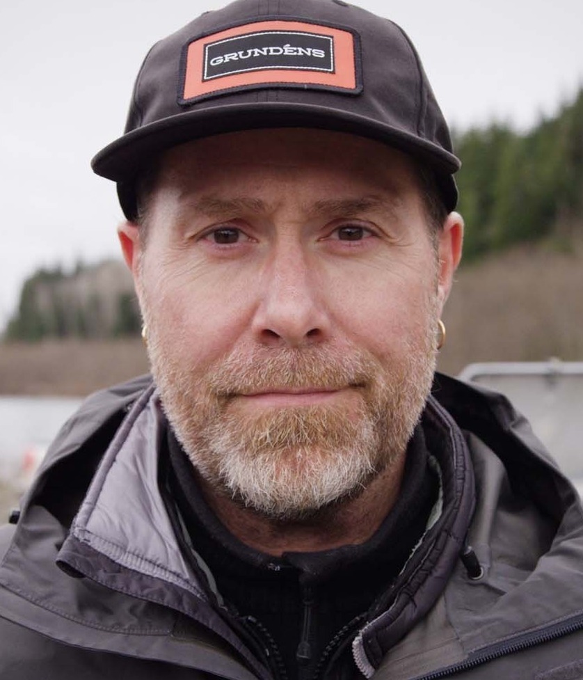 Claes Claesson staring directly in the camera wearing a Grundéns hat