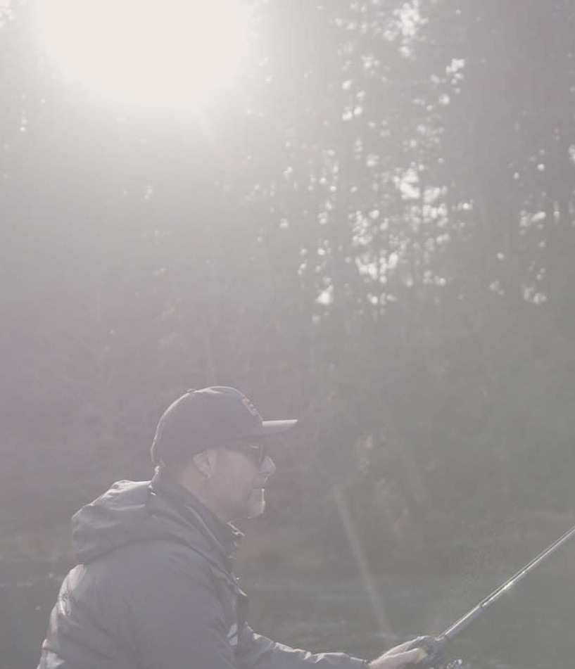 Claes Claesson casting his rod in the water with sun shining