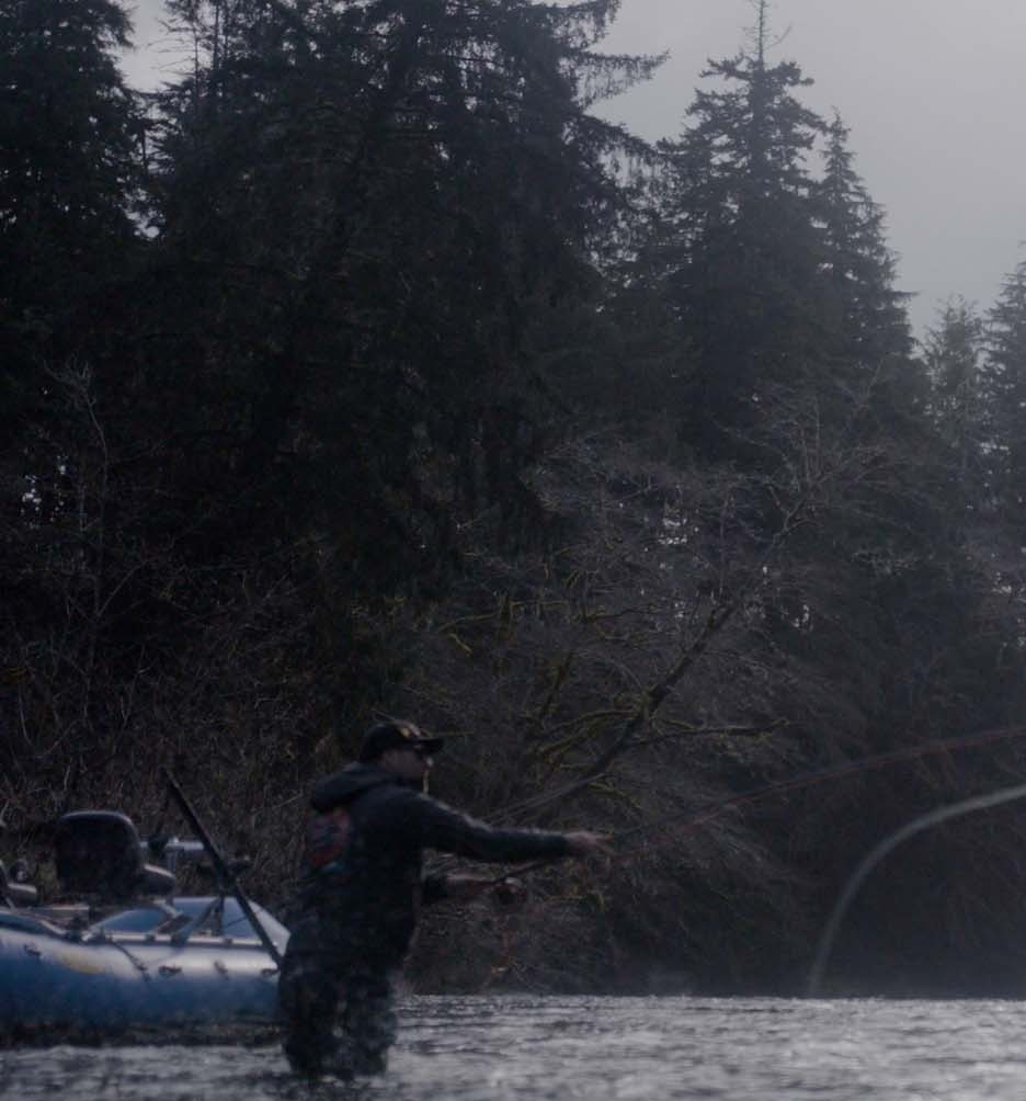 Claes Claesson casting his rod in a lake with rain falling