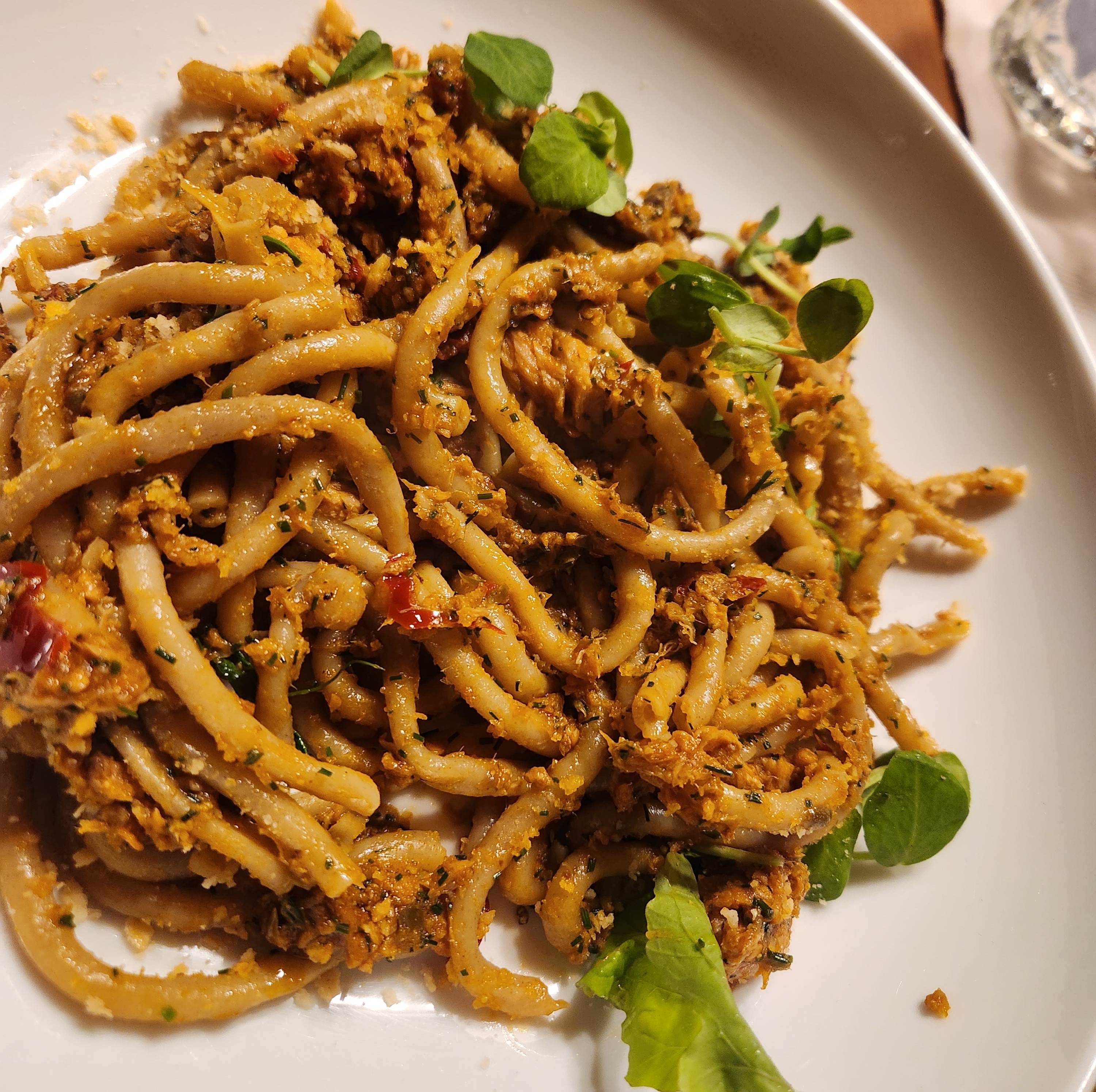 fresh bucatini pasta twirled with canned seasfood, lemon, garlic and breadcrumbs. delicious pasta recipe. 15 minute meal