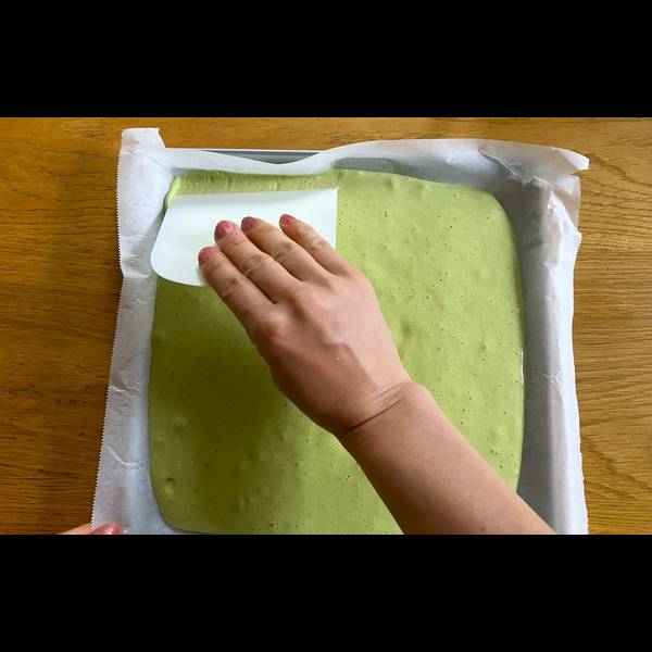 Spreading the cake batter evenly across the pan