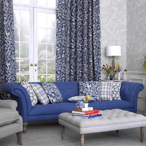 Blue cushions arranged on a sofa in a traditional, symmetrical style.