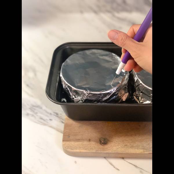 Making small holes in the foil to allow steam to escape