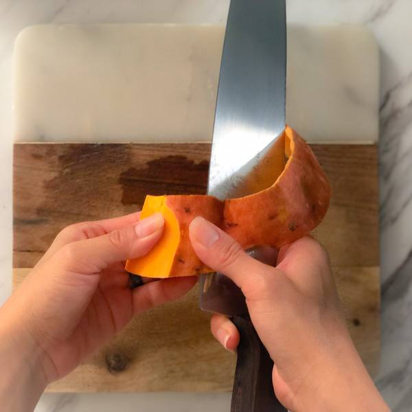 Peeling the skin from the sweet potato