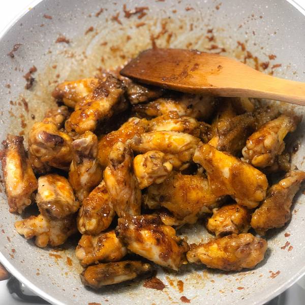 Tossing the wings in the sauce