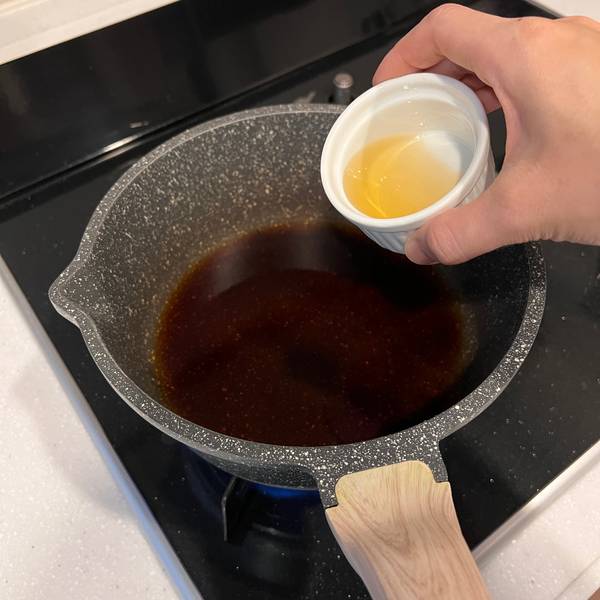 adding the sauce ingredients to a small pot