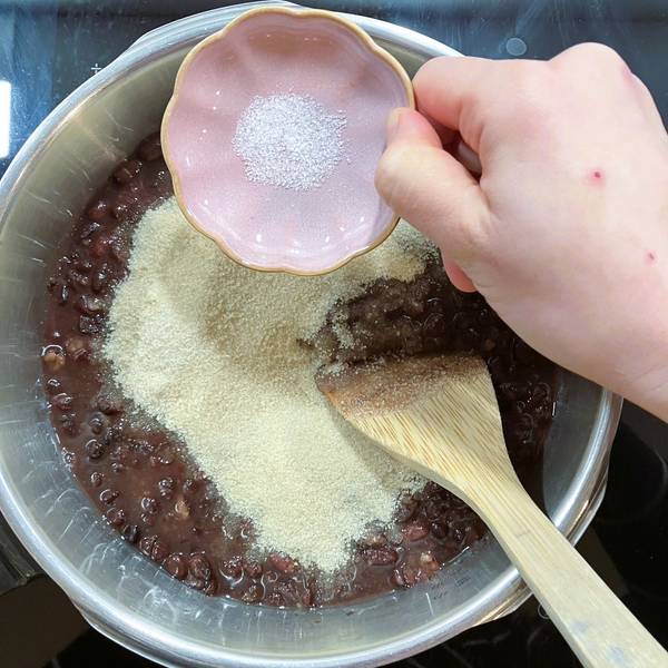 adding sugar and salt to the beans
