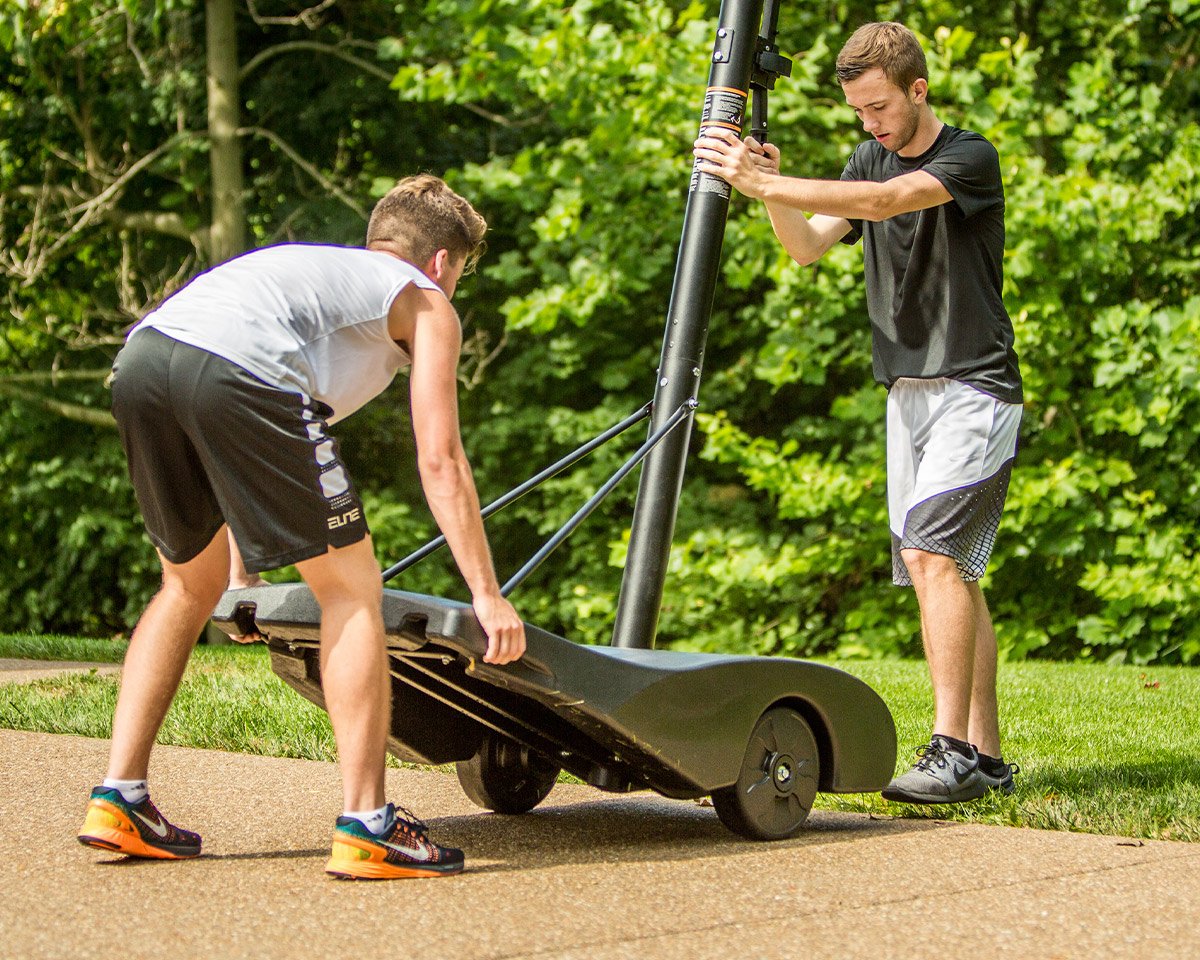 basketball players moving portable basketball hoop base