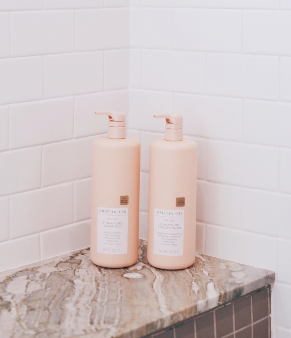 Kristin Ess Hair The One Signature Conditioner and Shampoo One Liter Bottles Lifestyle Image in Shower