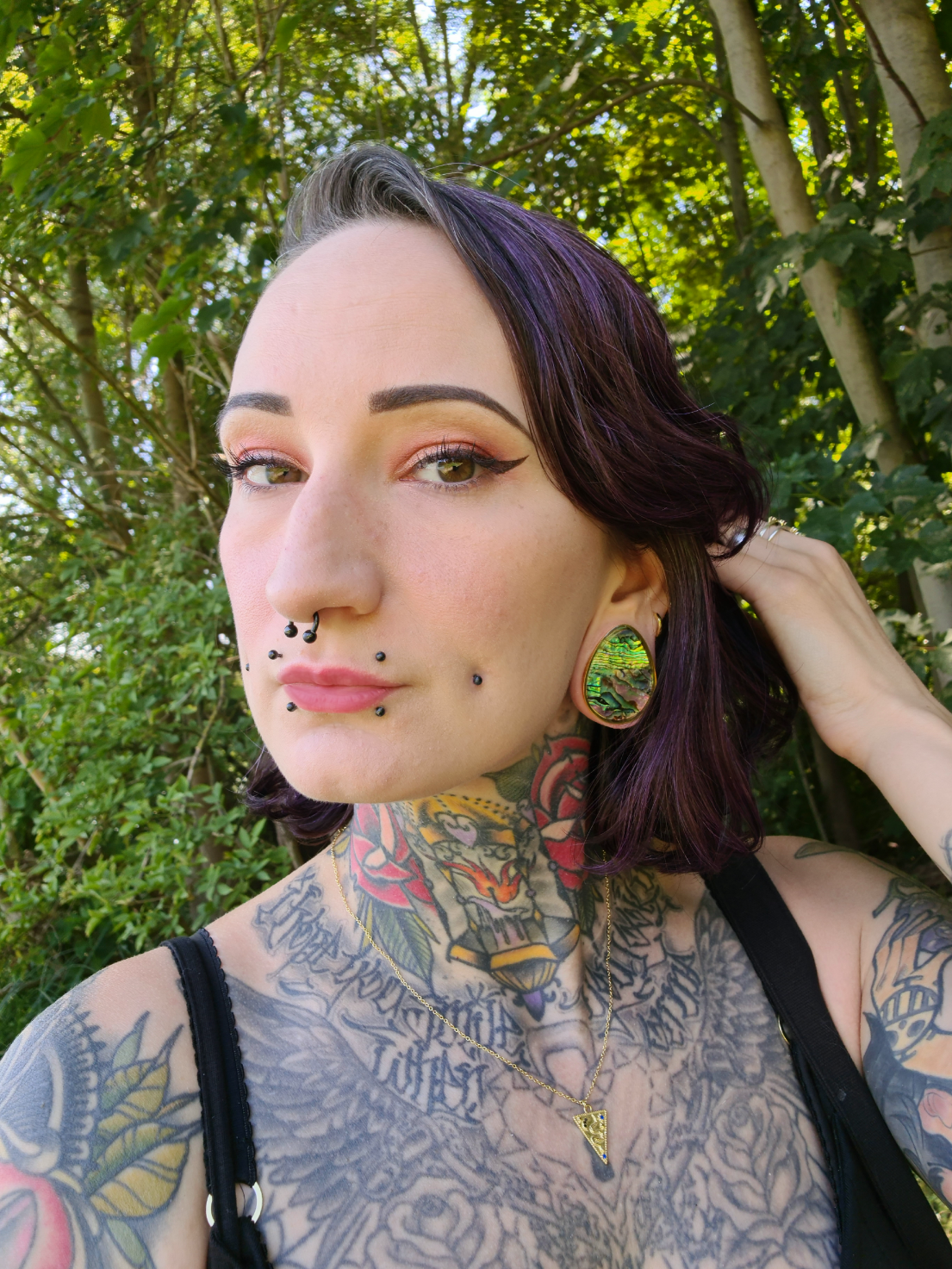 Pierced woman wearing cool  Abalone & Gold Steel Teardrop Plug / Gauge