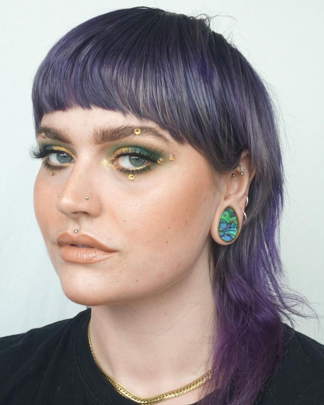 Girl wearing unique  Abalone & Gold Steel Teardrop Plug / Gauge