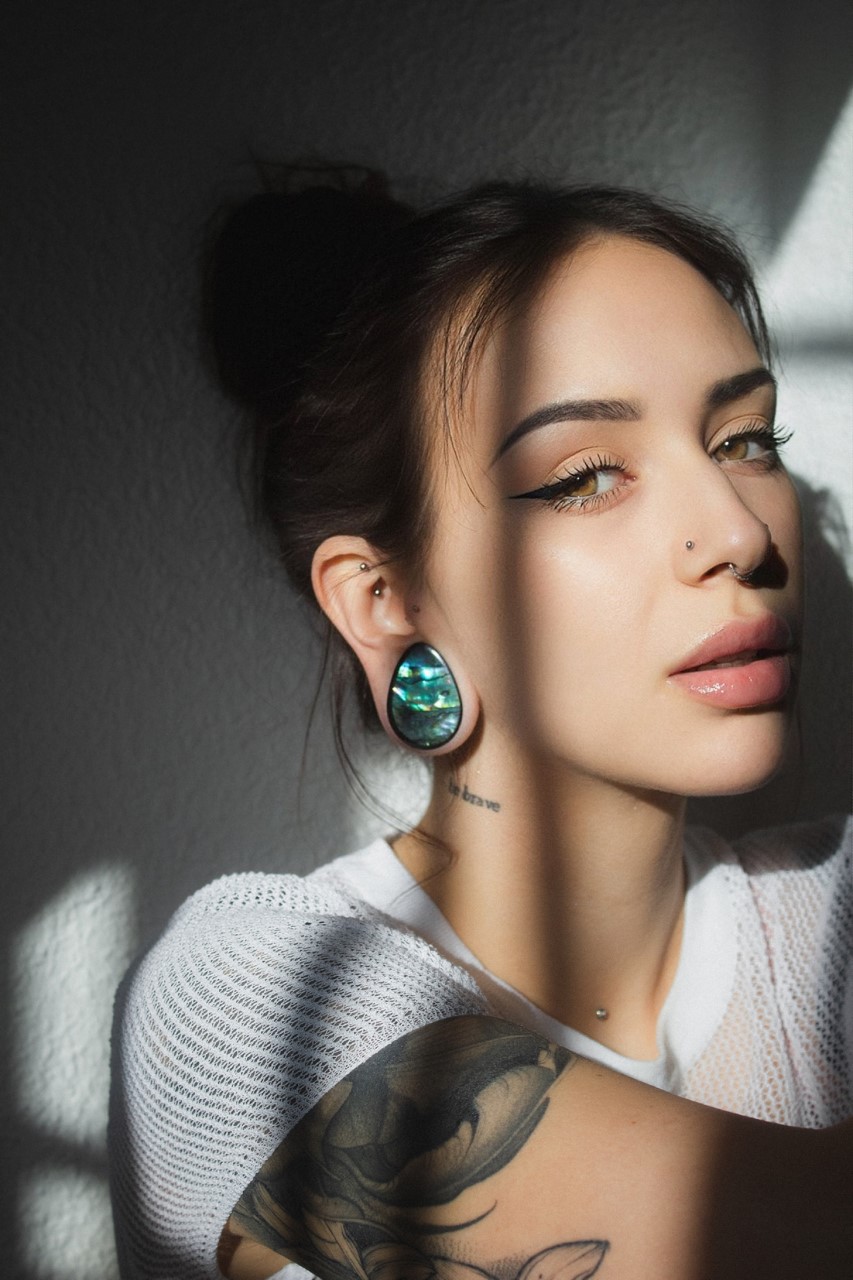 Girl wearing cute Abalone & Black Steel Teardrop Plug / Gauge