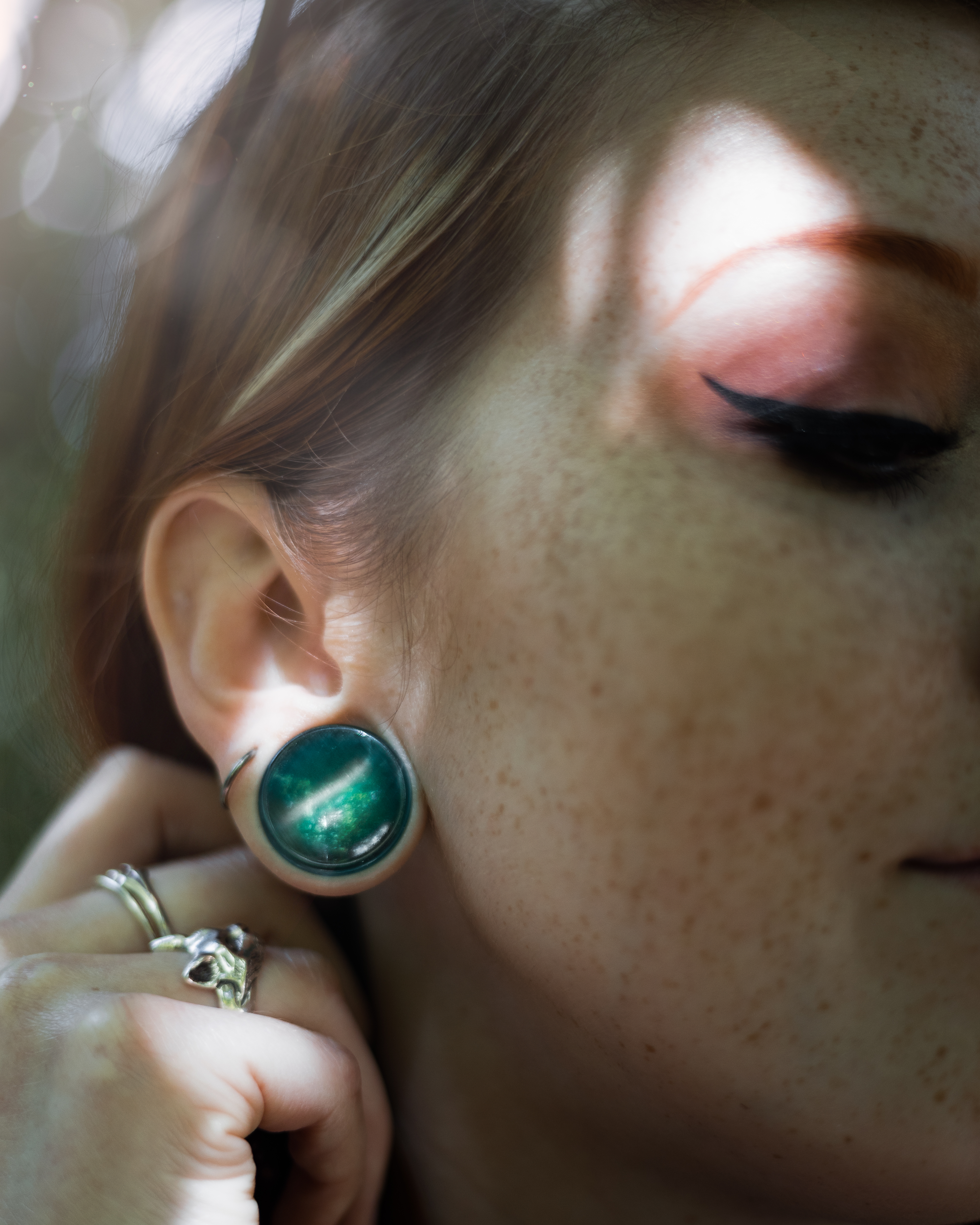 Girl wearing emo  Green Cats Eye Glass Plug Stretched Ears Jewellery / Gauge