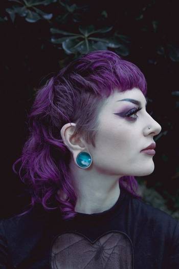Girl wearing unique Green Cats Eye Glass Plug Stretched Ears Jewellery / Gauge