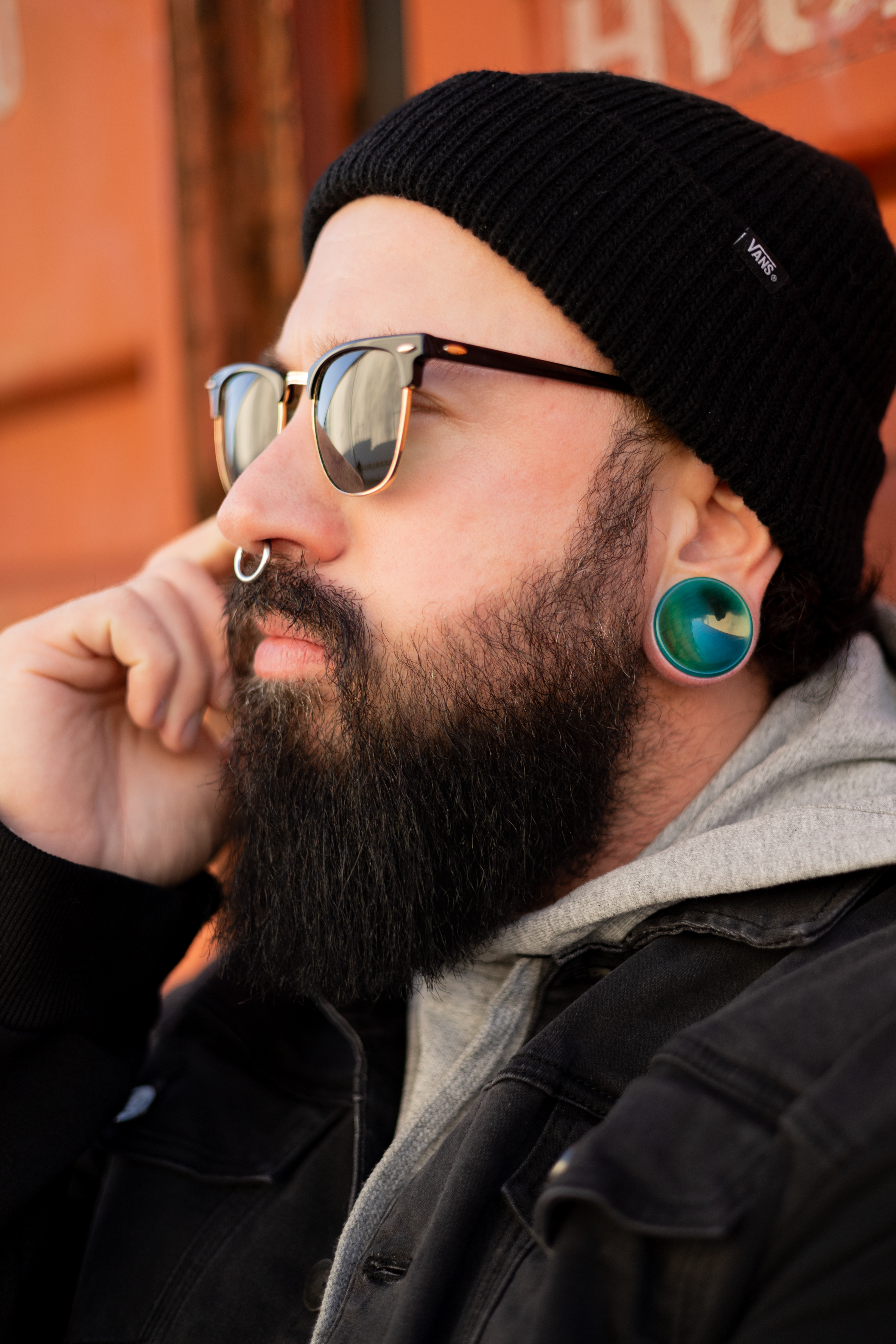 Man wearing unique  Green Cats Eye Glass Plug Stretched Ears Jewellery / Gauge