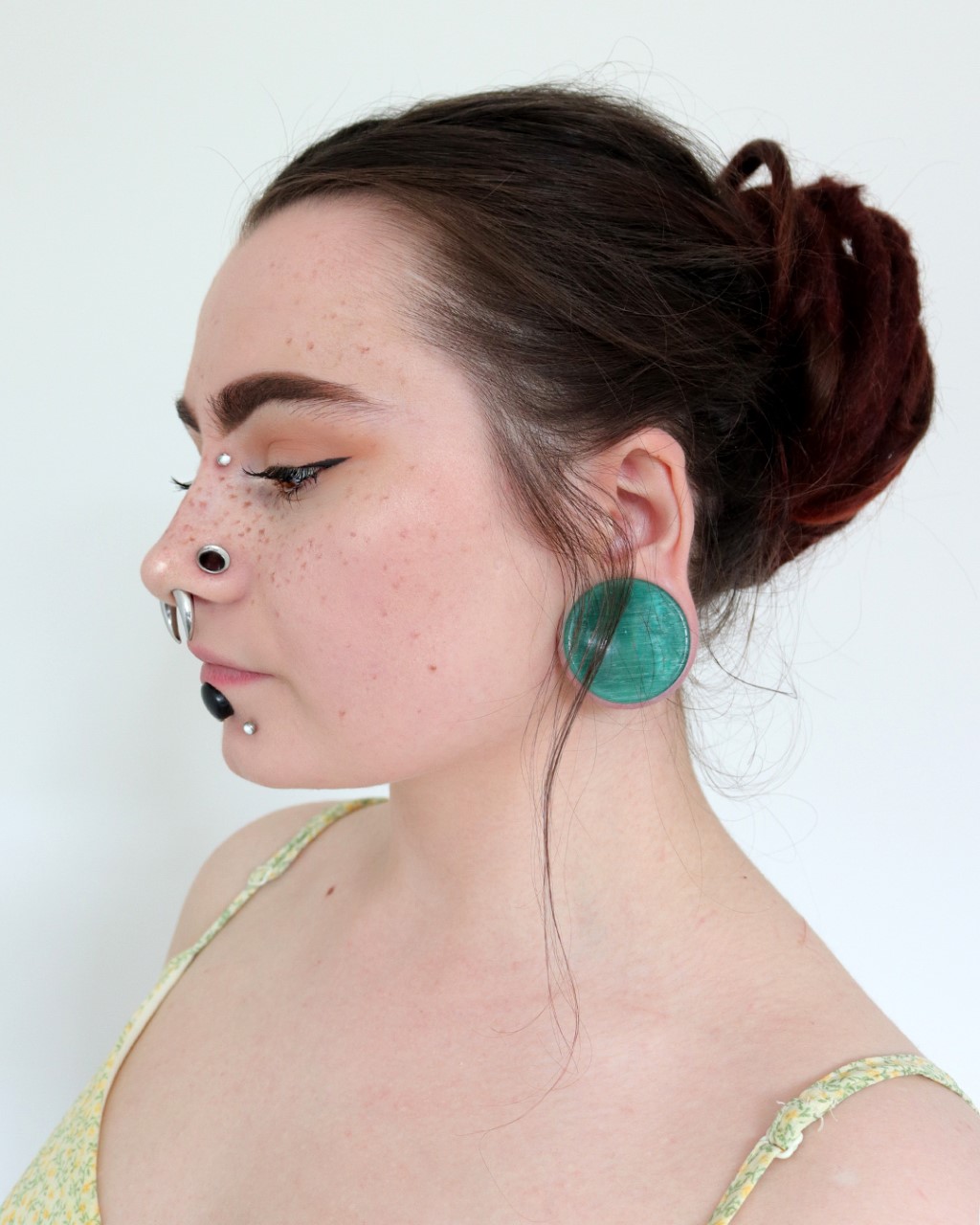 Girl wearing alternative  Green Cats Eye Glass Plug Stretched Ears Jewellery / Gauge