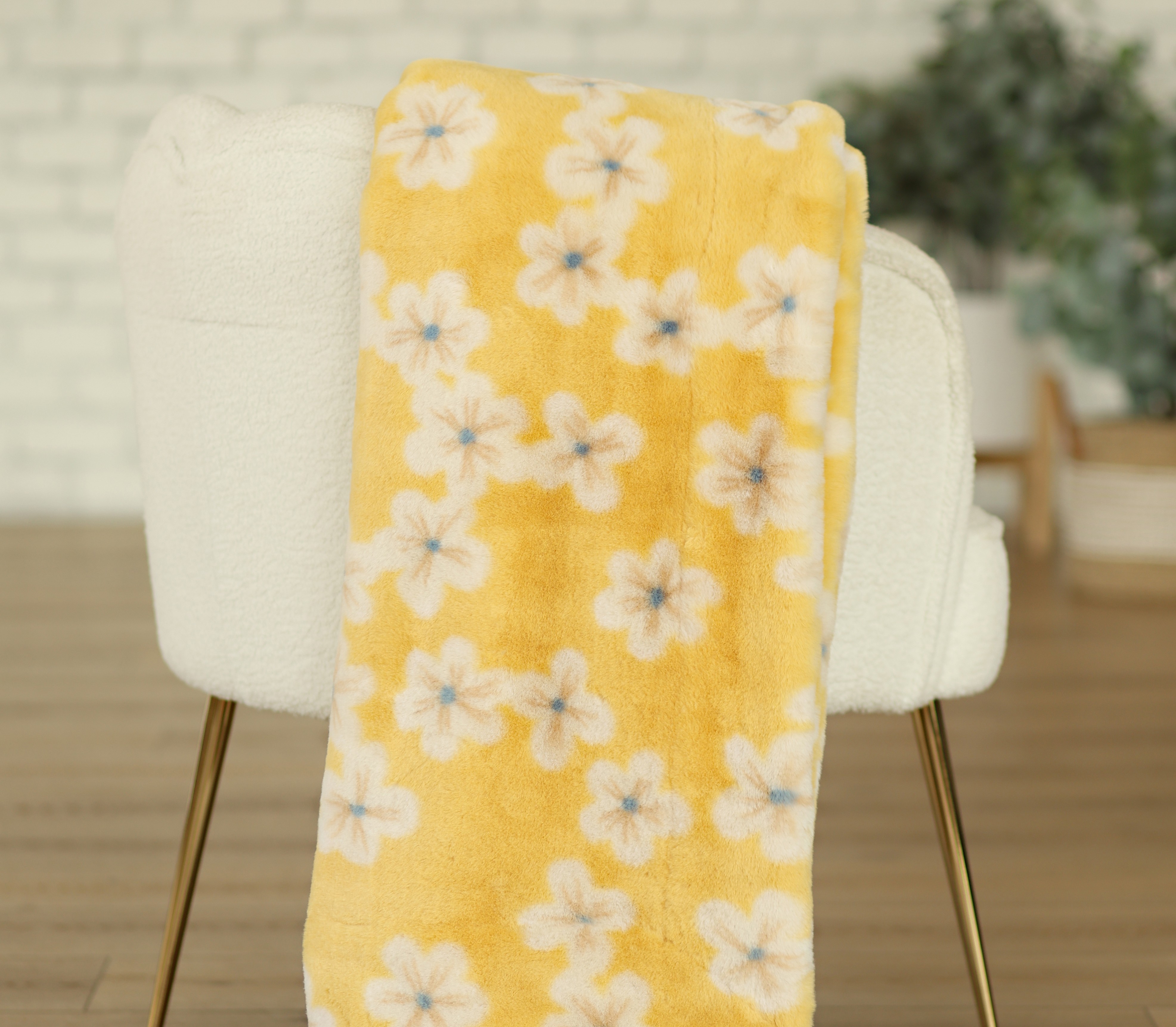 Yellow spring floral blanket adding soft seasonal color to a spring bedroom decor setup