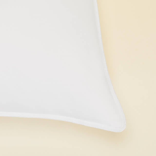 Close up image of the Slumber Cloud Core Down Alternative Pillow corner stitching