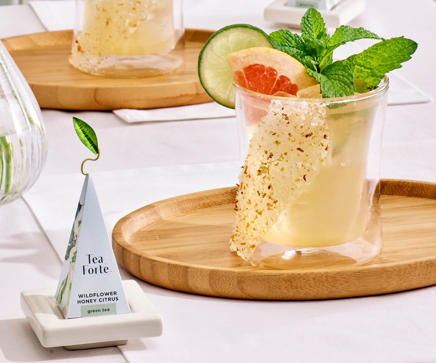 Wildflower Honey Citrus Mojito in a Poom glass with an infuser on a table