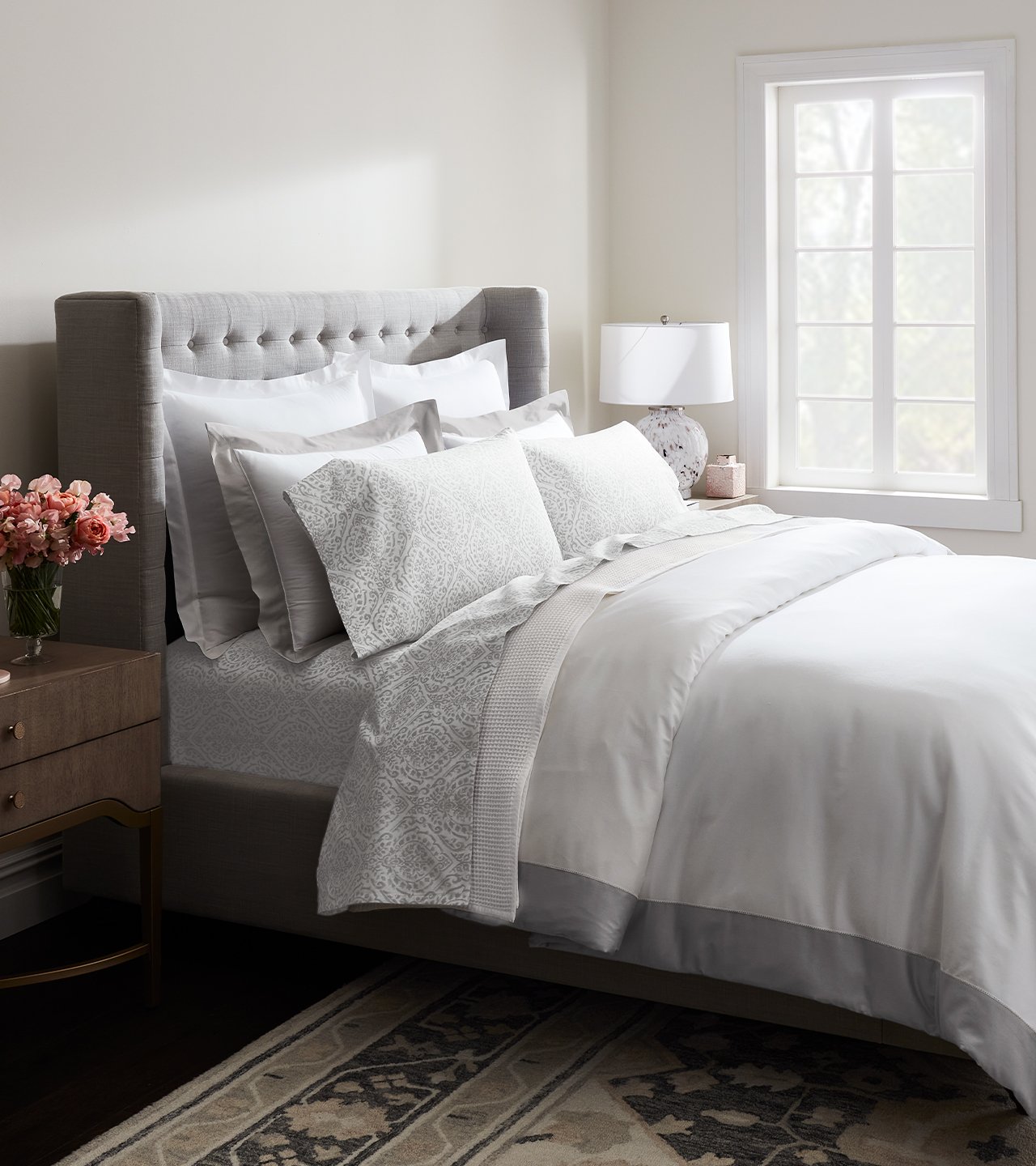 Side shot of bed with white sheets