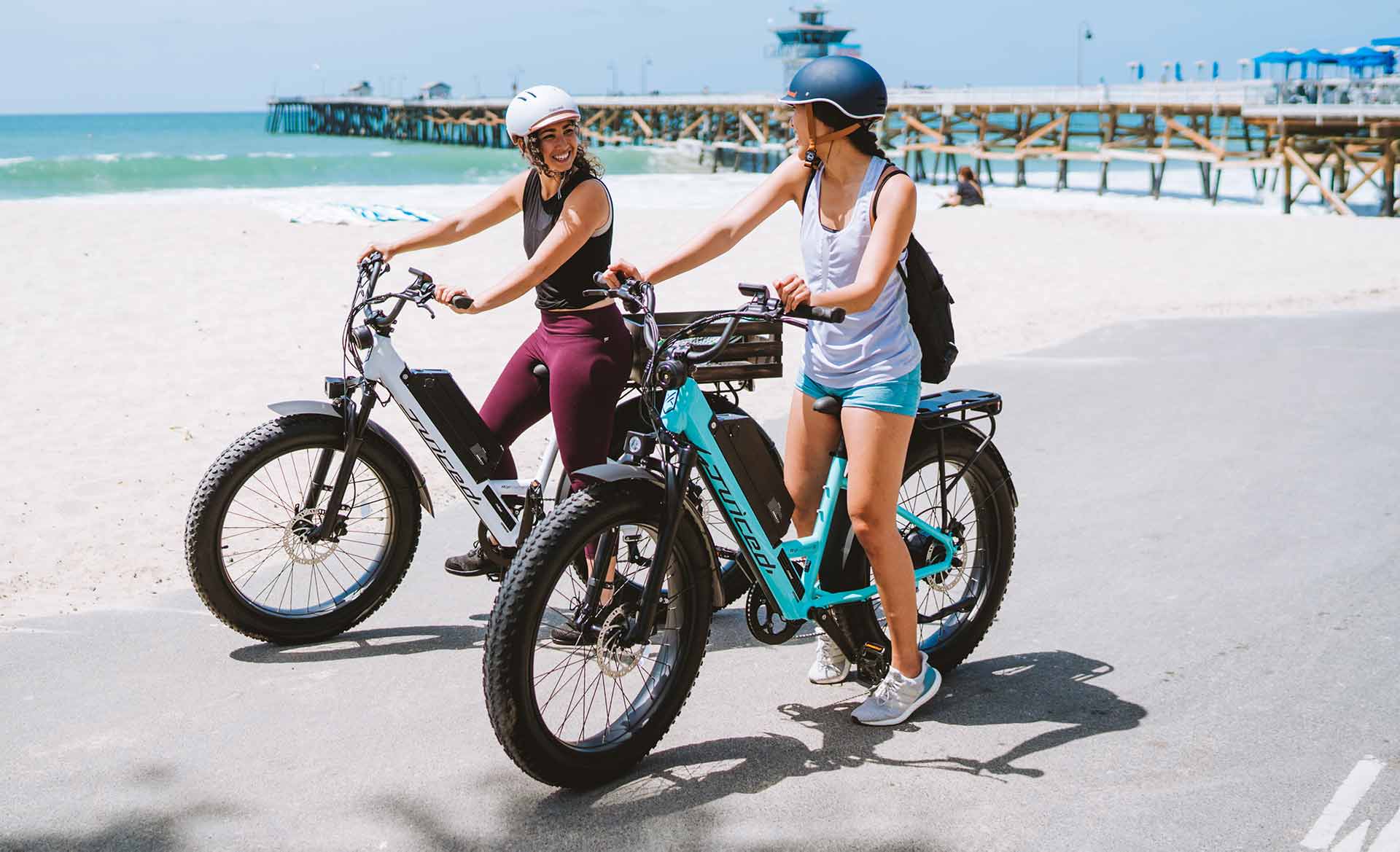Women riding with juiced bikes ripcurrent s step-through electric bikes