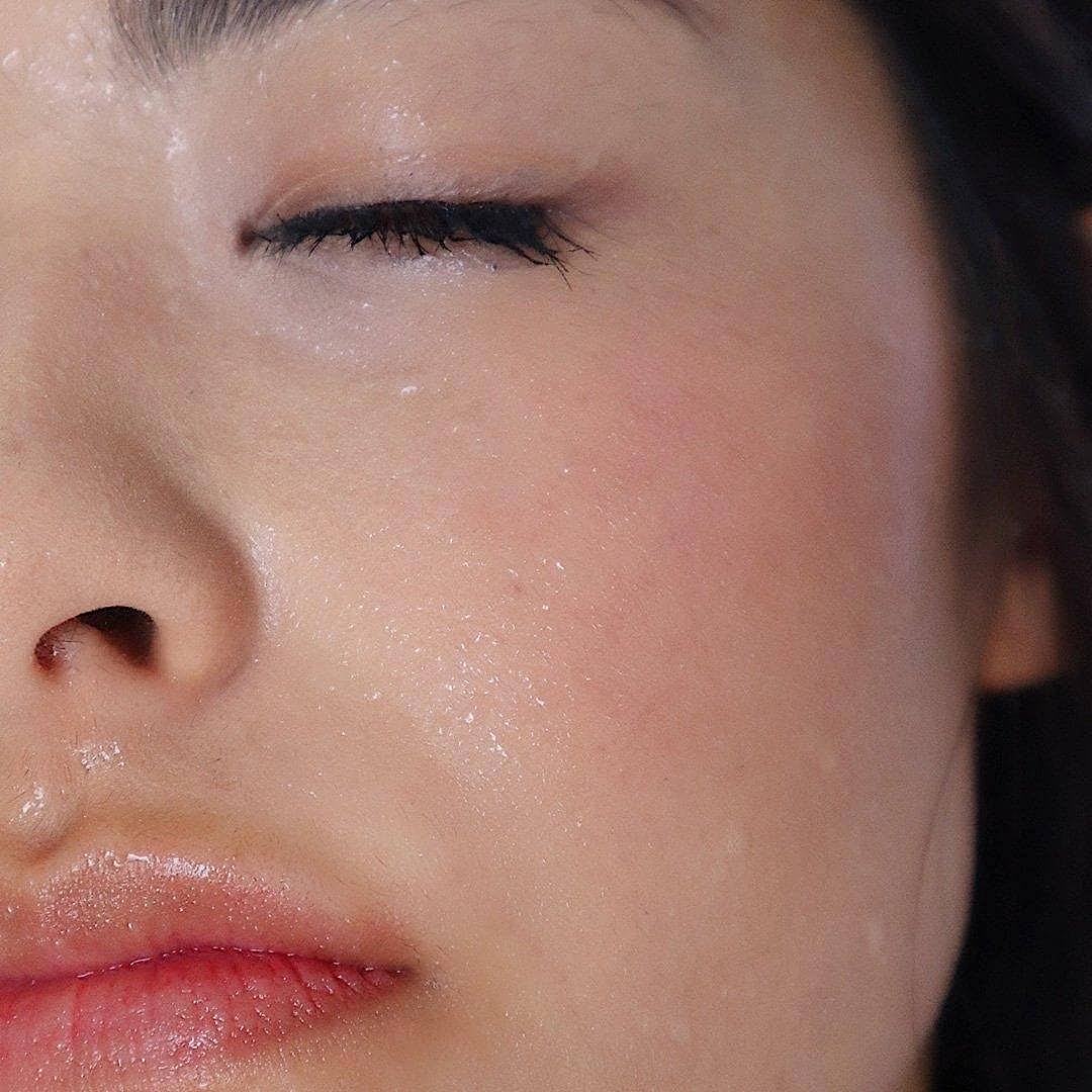 Woman using the nano glow facial steamer for dewy skin