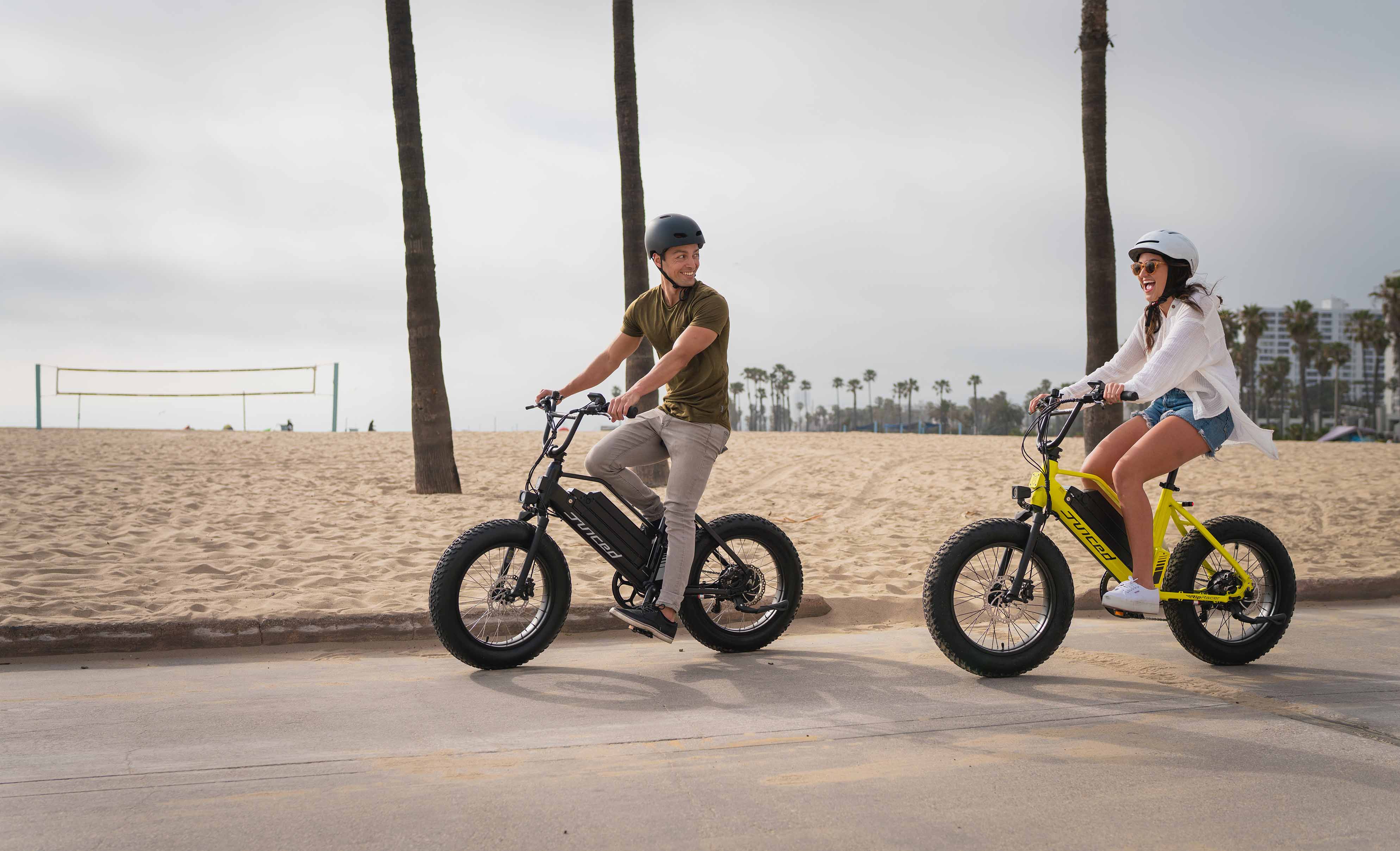man and woman riding juiced ripracer electric bikes