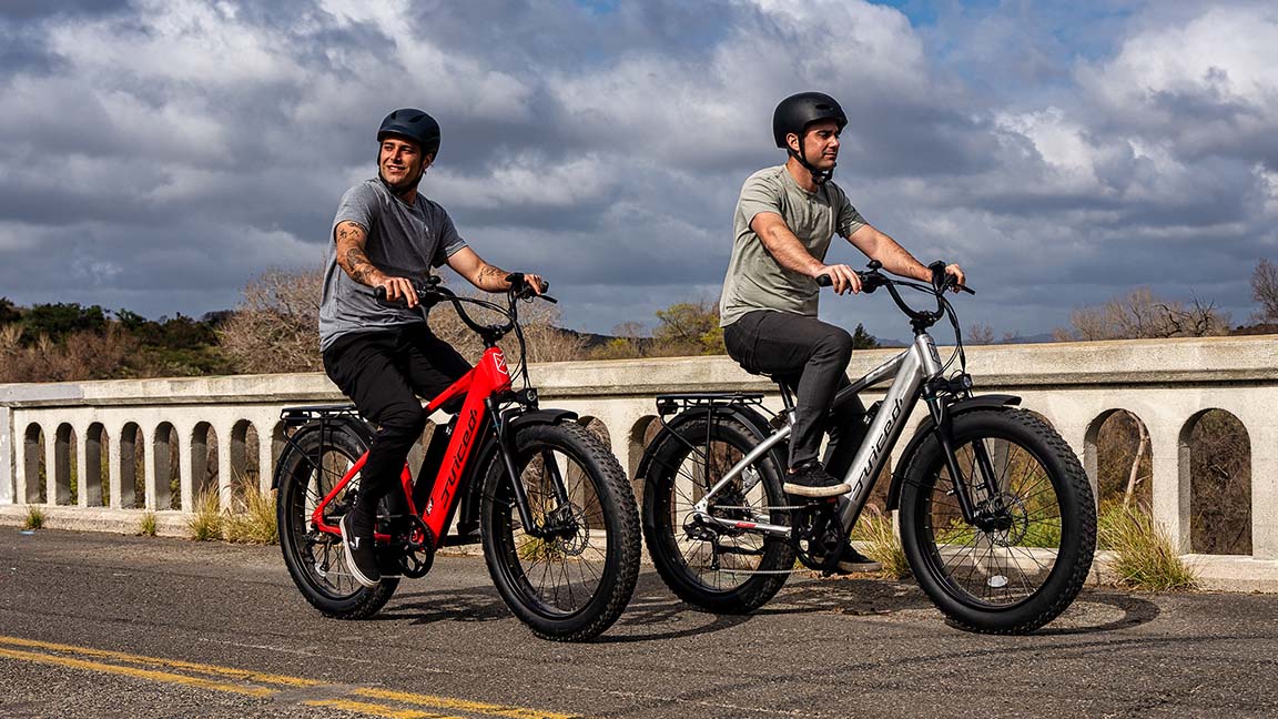 two men riding juiced ripcurrent s ebikes