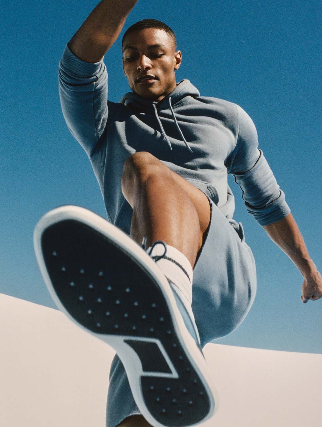 Man jumping, featuring the sole of the Crossover Victory Trainer in Navy.