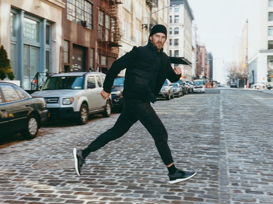 Full body image of of man running across the street walking wearing Swiftknit Derby WTZ