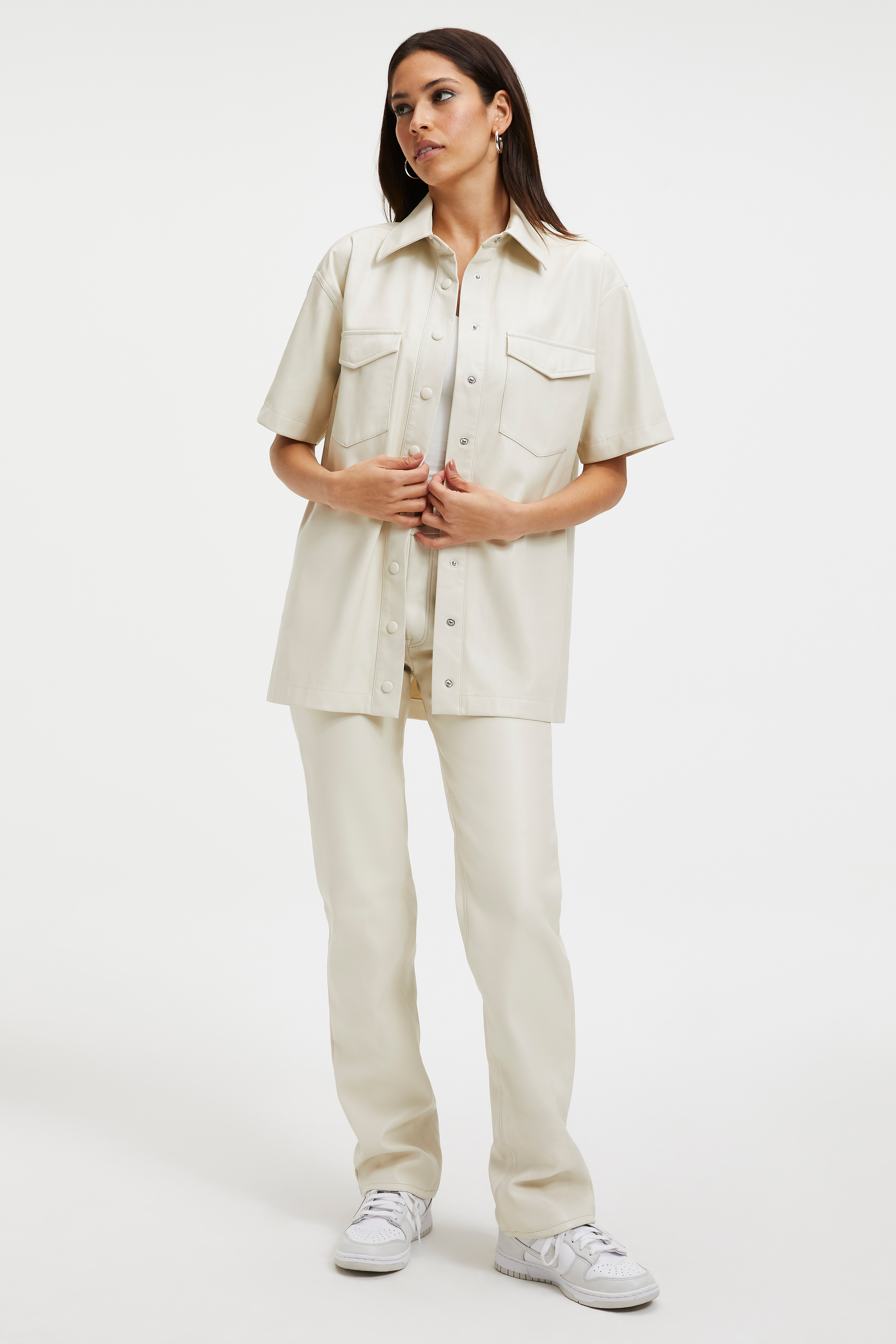 FAUX LEATHER SHORT SLEEVE SHIRT in BONE001 styled with our RIB FITTED TEE BODYSUIT in WHITE001, RACERBACK TANK BODYSUIT in WHITE001, or GOOD ICON FAUX LEATHER PANTS in BONE001