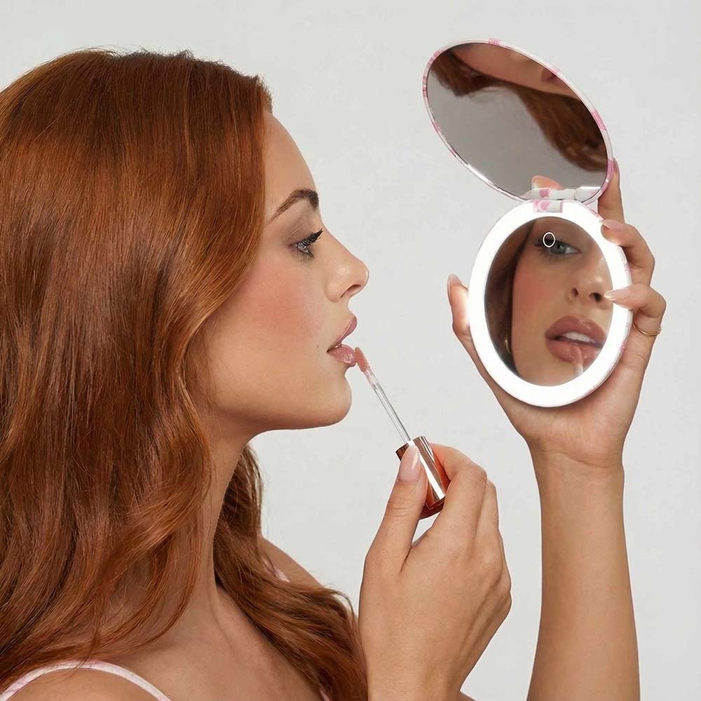 Woman using the Taylor lighted compact mirror