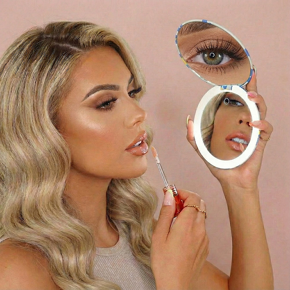 Woman using the Taylor lighted compact mirror