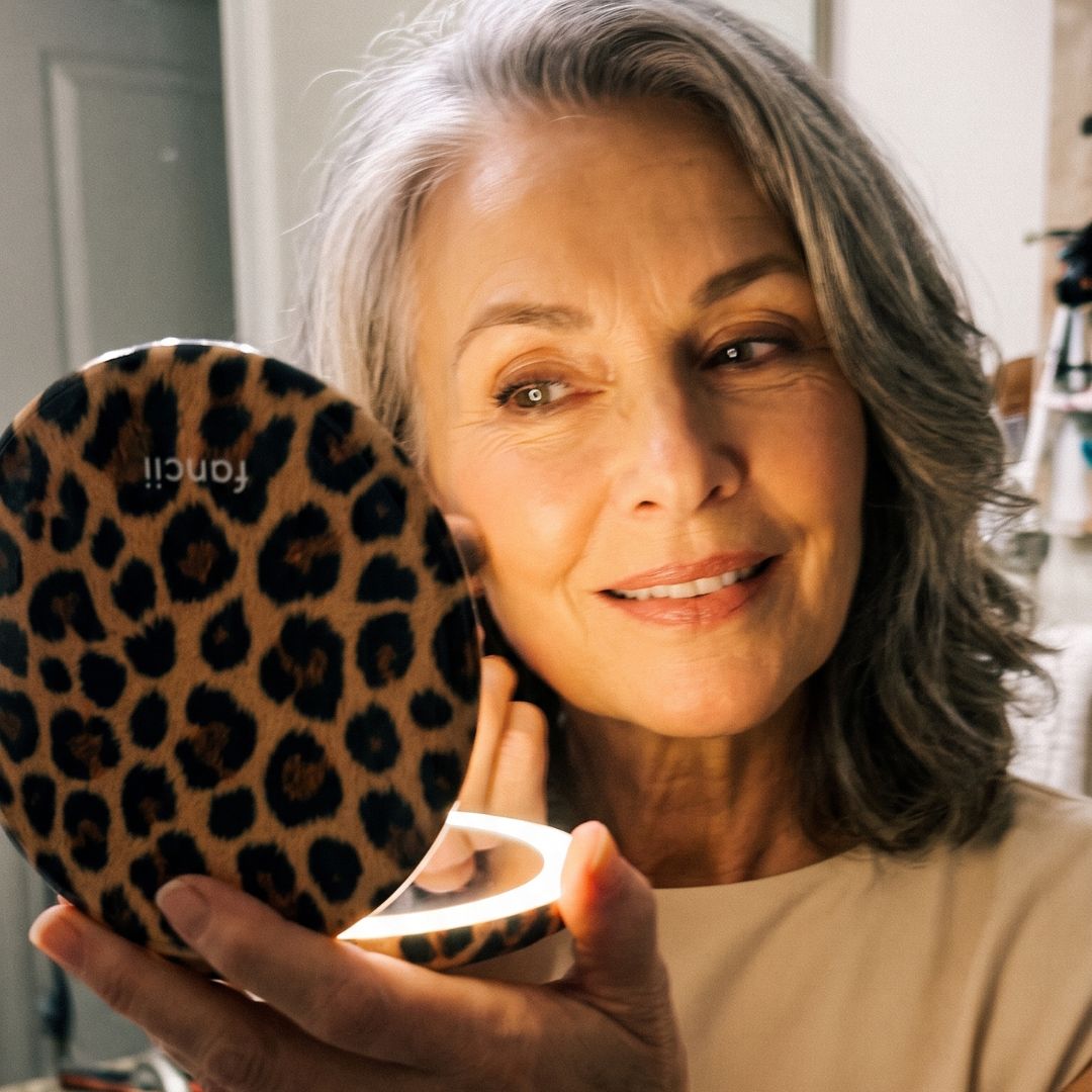Woman using the Taylor lighted compact mirror