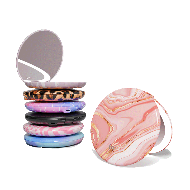 Taylor compact mirror by Fancii in the love train pattern open with 1X and 10X magnifying mirrors