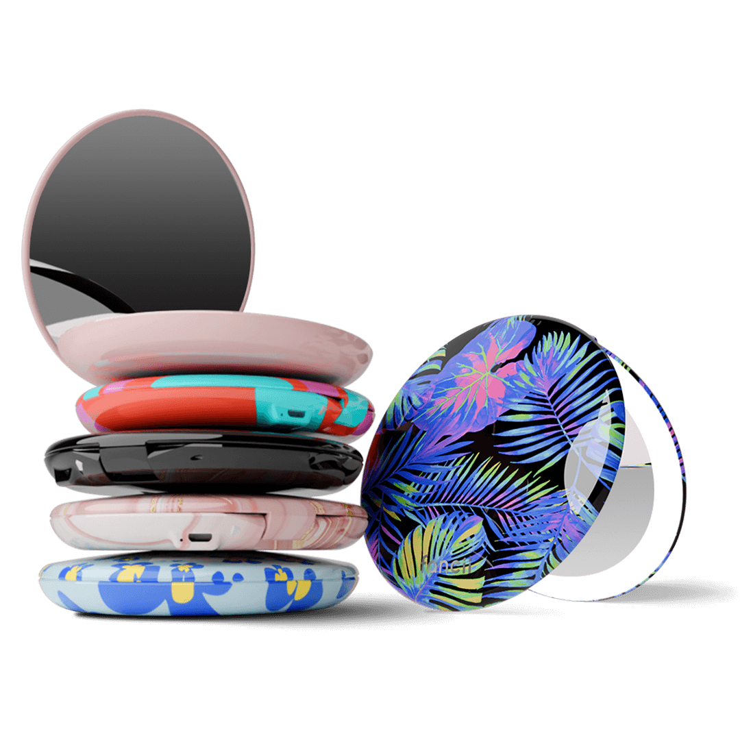 Taylor compact mirror by Fancii in the love train pattern open with 1x and 10x magnifying mirrors