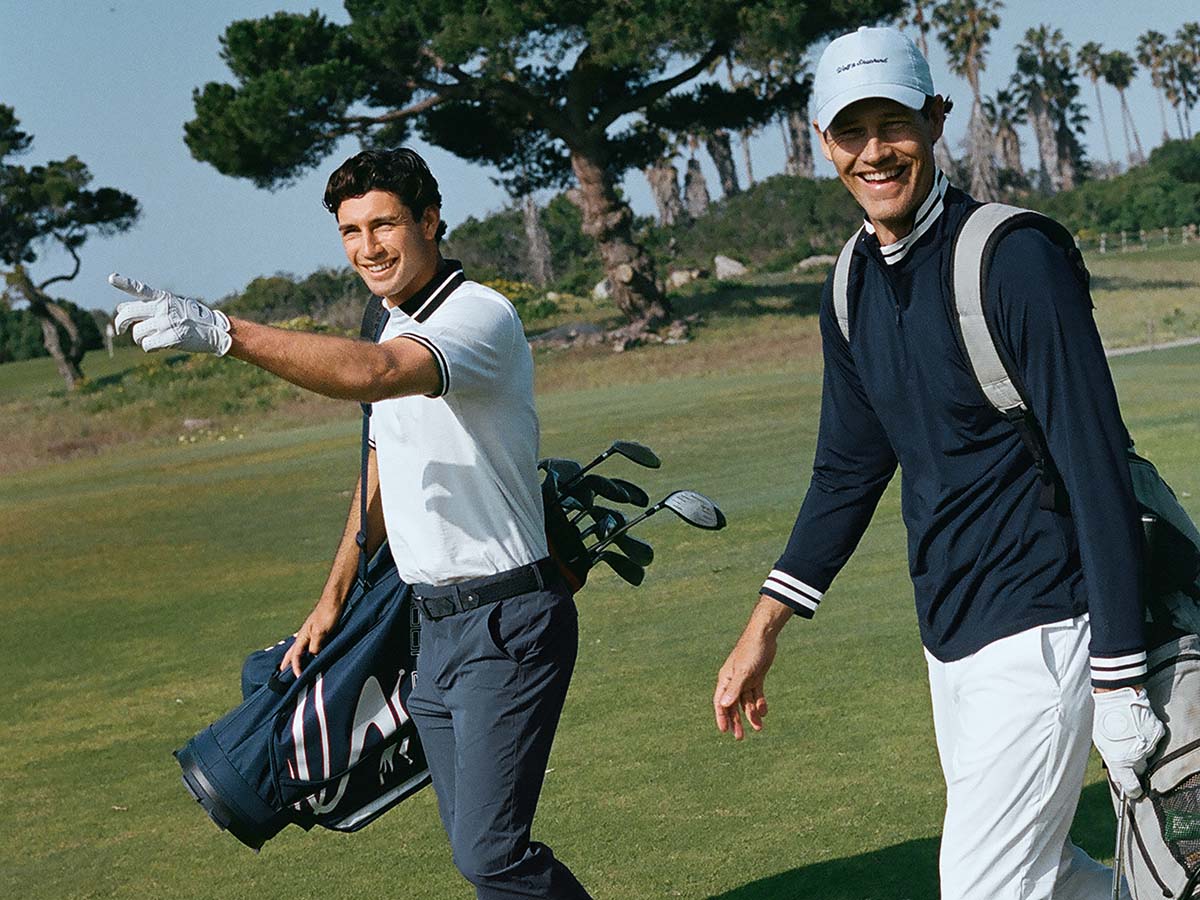 Two men walking on a golf course