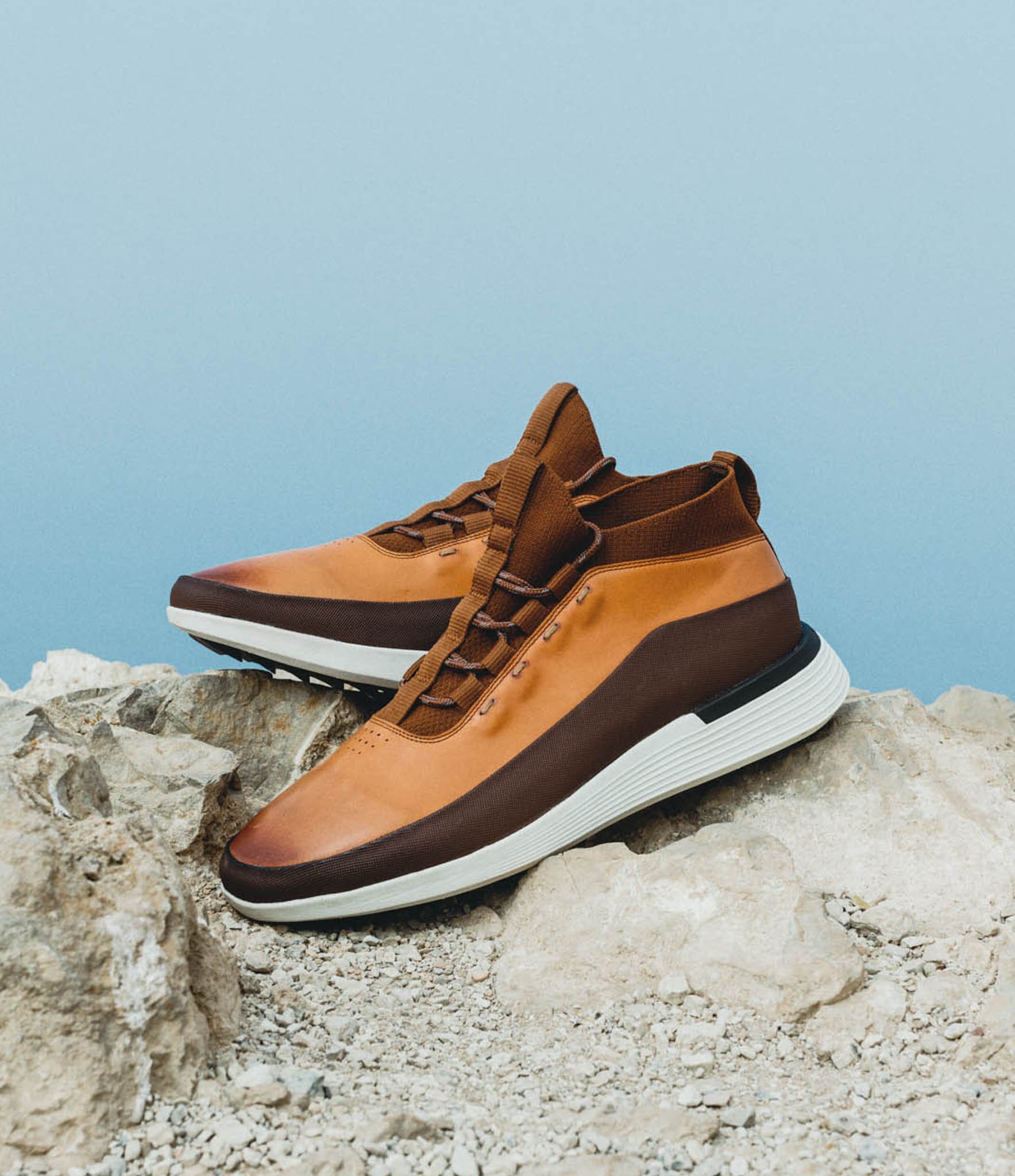 Side view of Men's Boot Crossover Mid WTZ in Honey on a rock with the ocean in the background