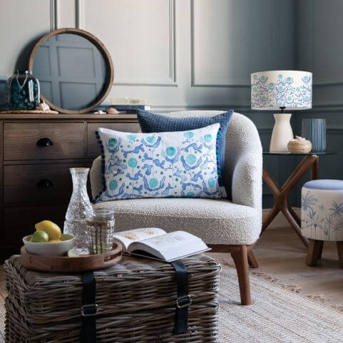 A selection of summer style cushions and other accessories arranged in a living room.