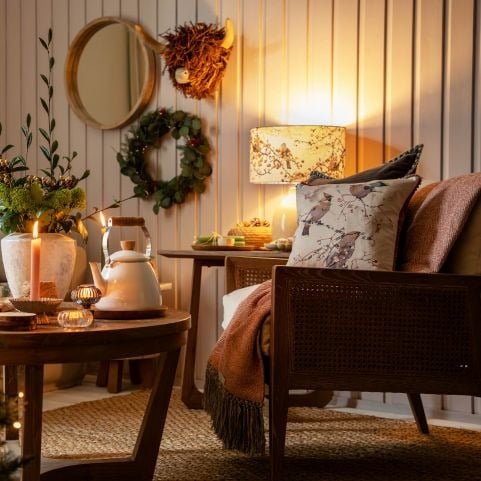 A wall-mounted highland cow bust in a decorated living room setting.