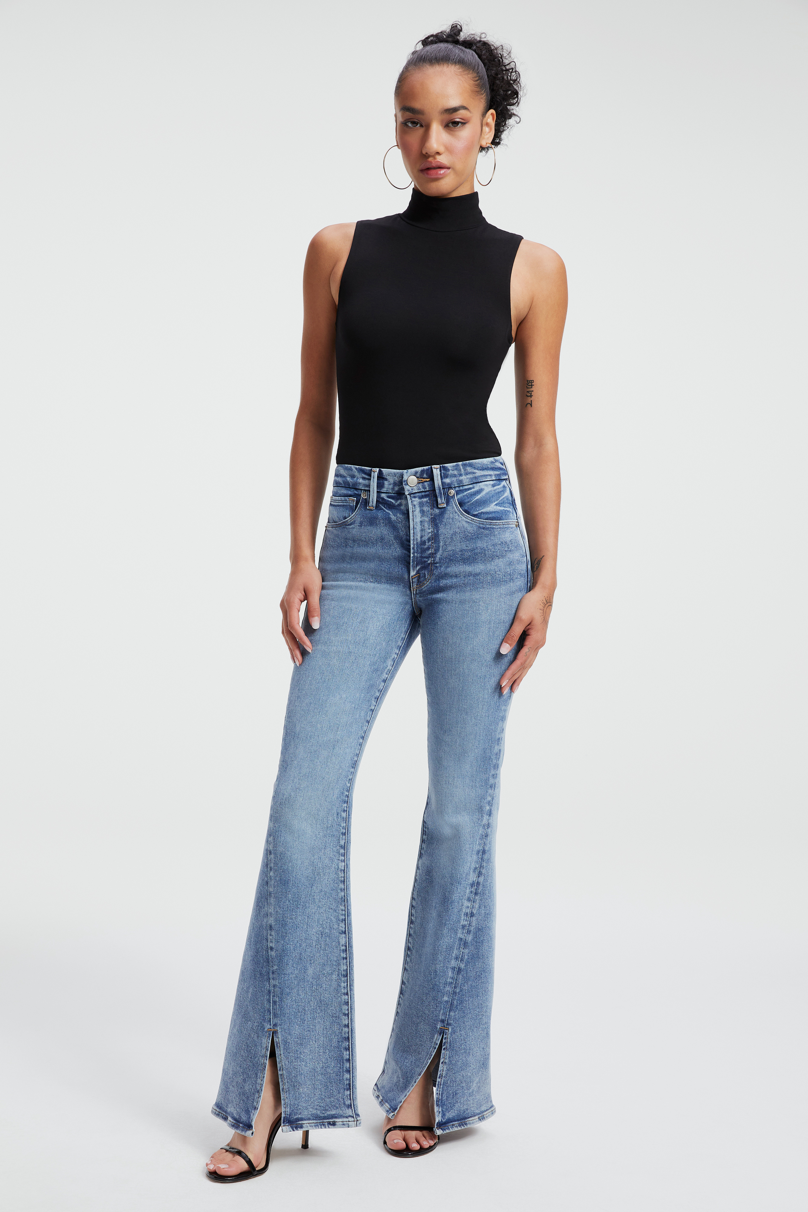 GOOD LEGS FLARE LIGHT COMPRESSION JEANS in INDIGO255 styled with our SCUBA FUNNEL TANK BODYSUIT in BLACK001, or COMPRESSION SHINE BODYSUIT in BLACK001