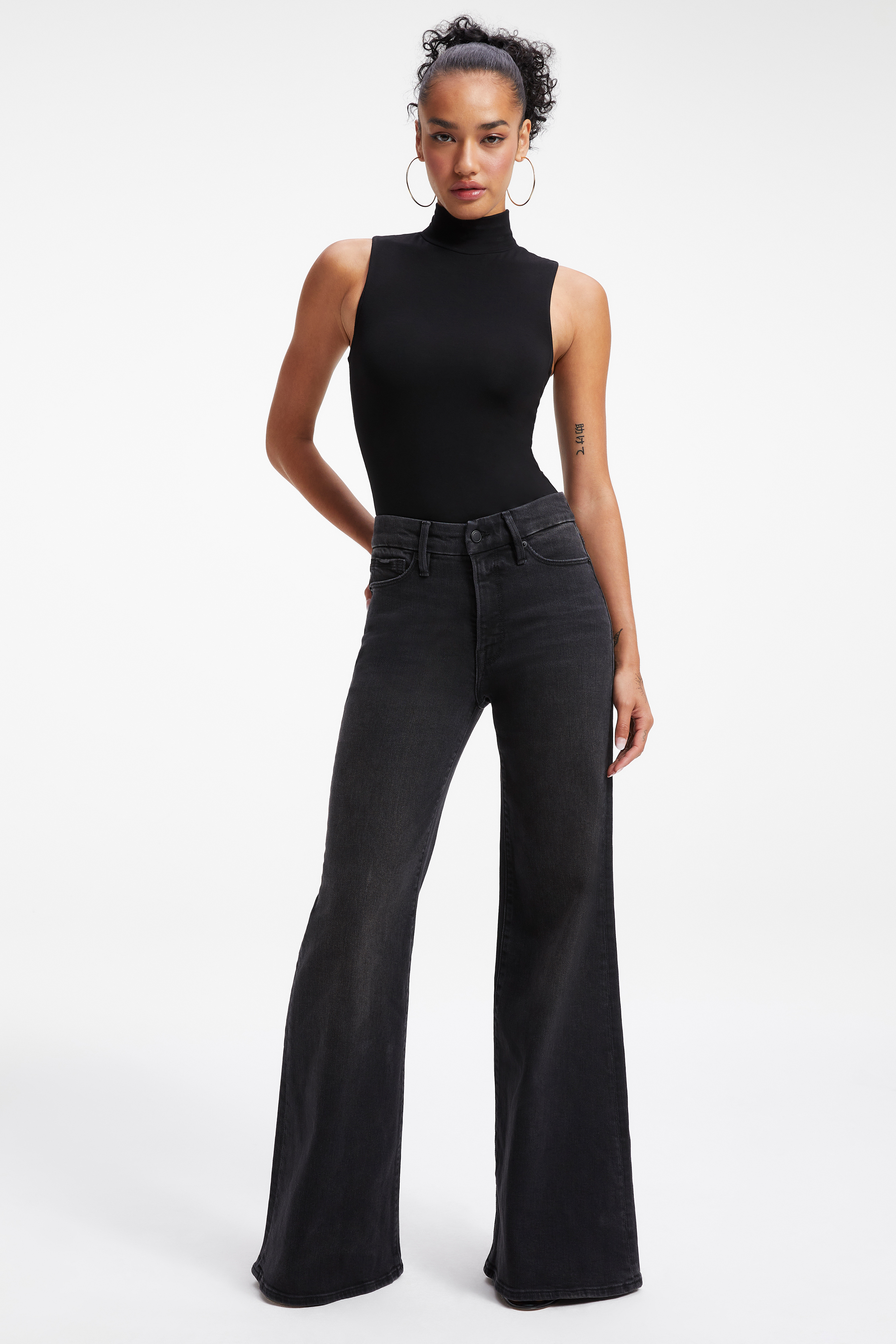 GOOD WAIST PALAZZO JEANS in BLACK289 styled with our SO SOFT SLEEVELESS BODYSUIT in BLACK001, SCUBA SPAGHETTI BODYSUIT in BLACK001, or GOOD TOUCH ONE SHOULDER '90s BODYSUIT in BLACK001