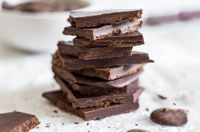 A stack of chocolate bark made with Navitas Organics Bittersweet Cacao Wafers.