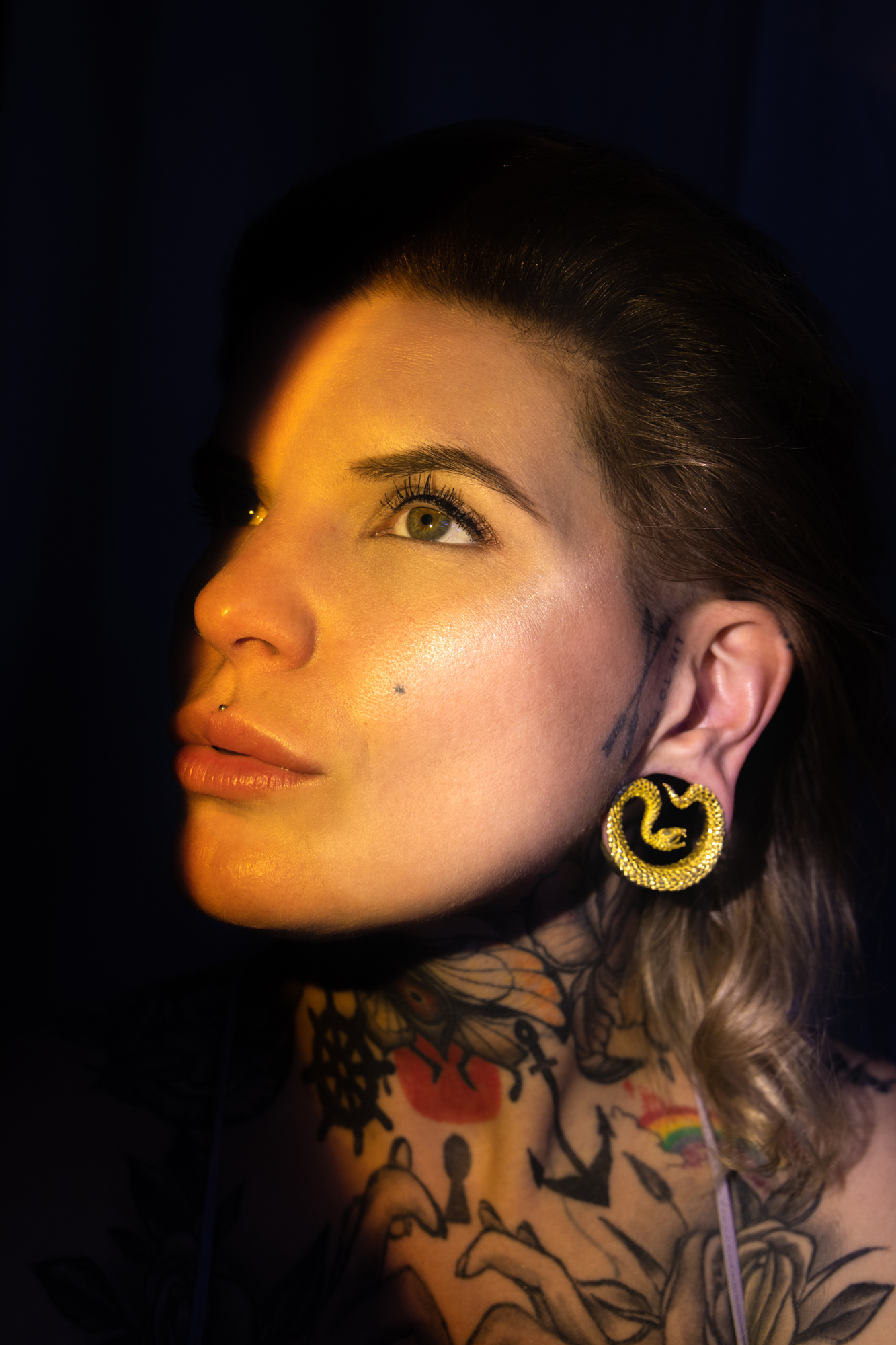 girl wearing large  Gold Snake Saddle Metal Ear Gauge / Plug