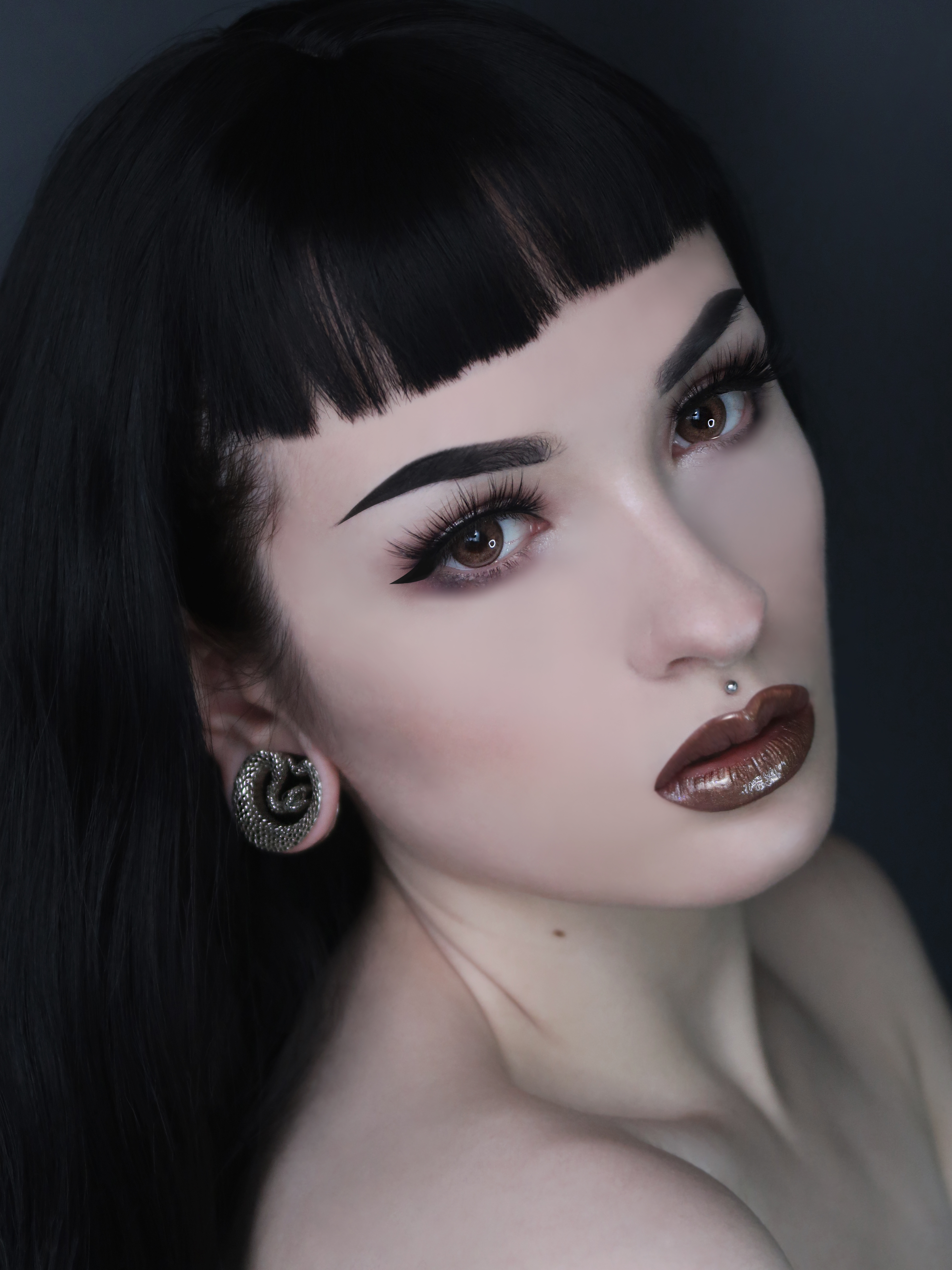 Women wearing large Silver Snake Saddle Metal Ear Gauge / Plug