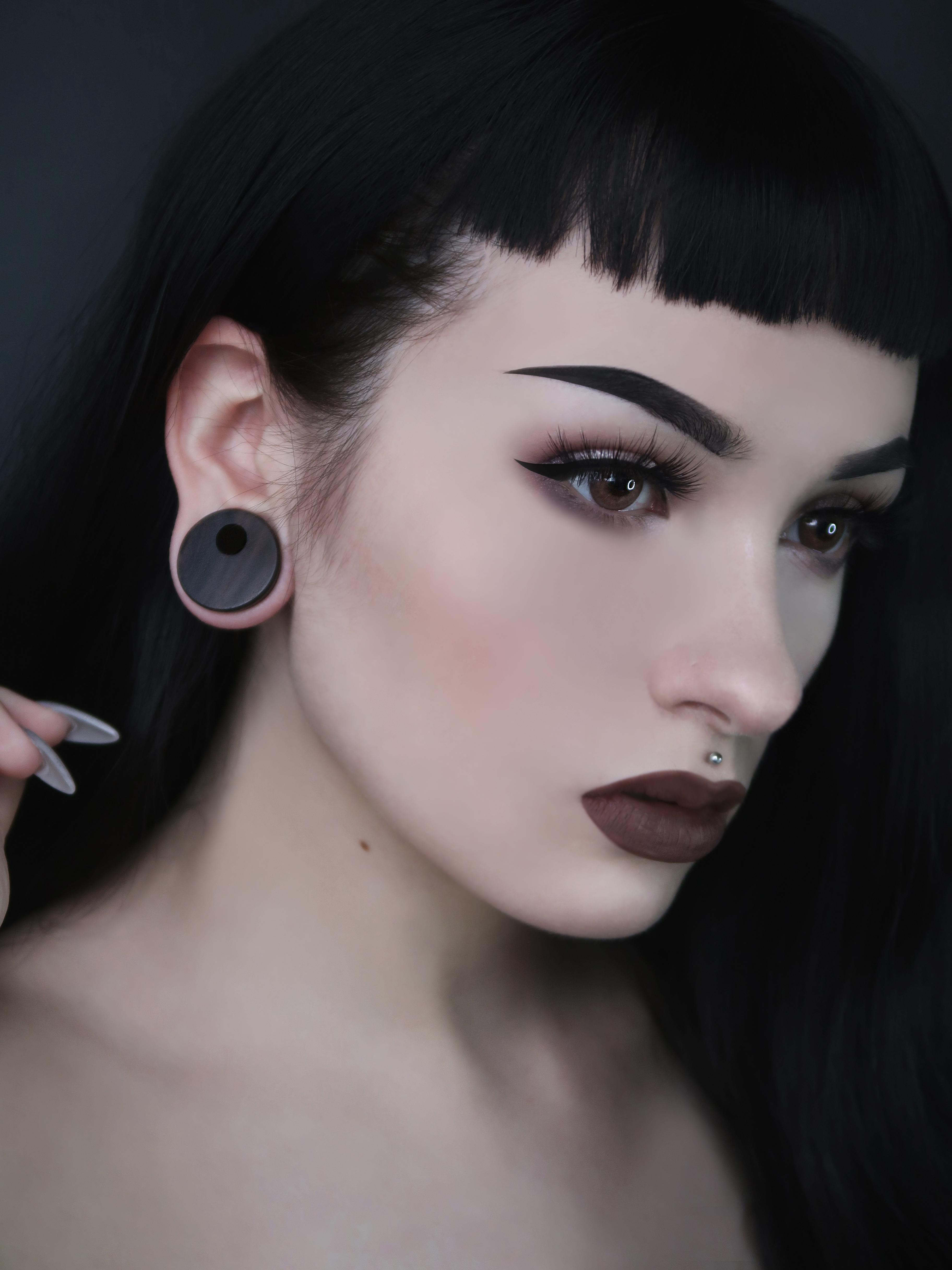 Girl wearing goth Black Ebony Offset Hole Wood Tunnel