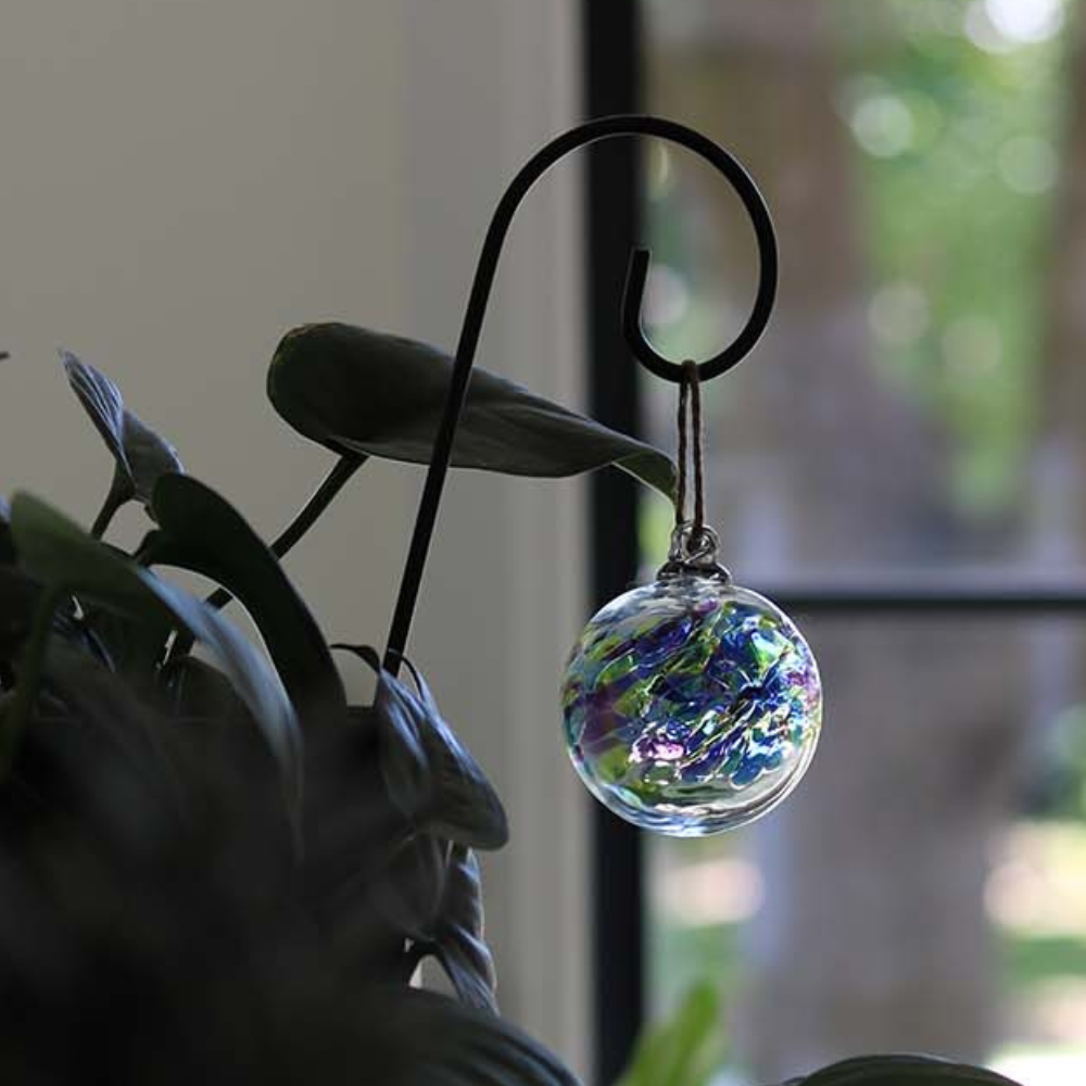 September Orb on a Small Shepherd's Hook Stake amongst greenery.