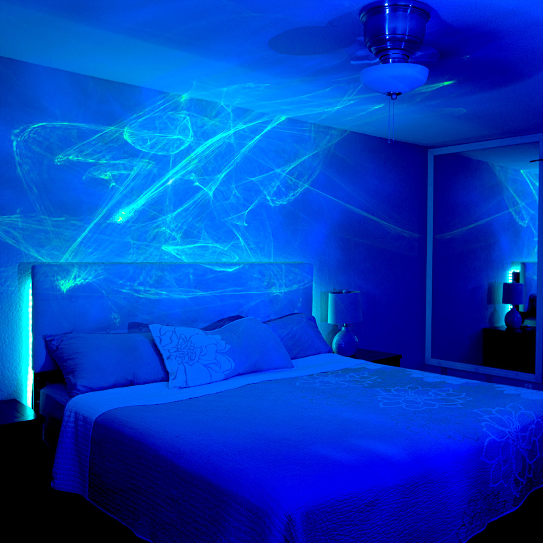 bedroom with ark aurora light shining over headboard