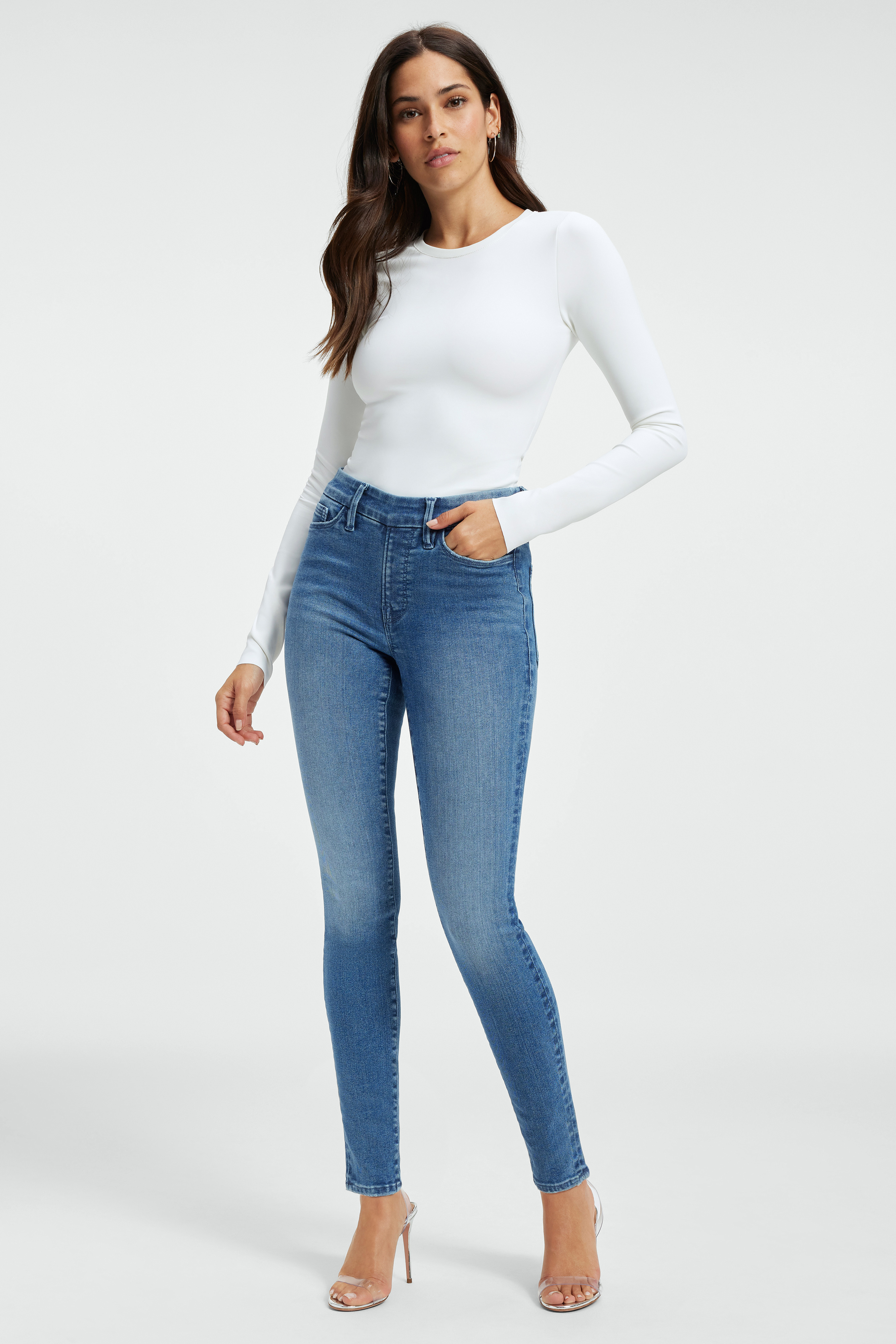 POWER STRETCH PULL-ON SKINNY JEANS in INDIGO490 styled with our THE CREWNECK BODY in WHITE001, SCUBA CREW BODYSUIT in WHITE001, or SOFT RIBBED HALTER BODYSUIT in BLACK001